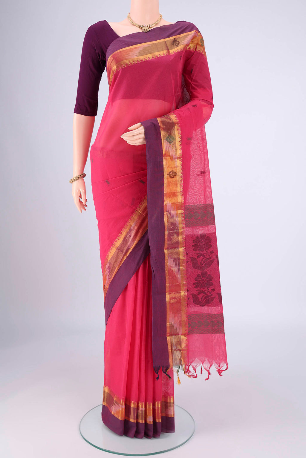 Pink Kanchi Cotton Saree with Thread Butta on the body and Zari Border.  displayed on a mannequin
