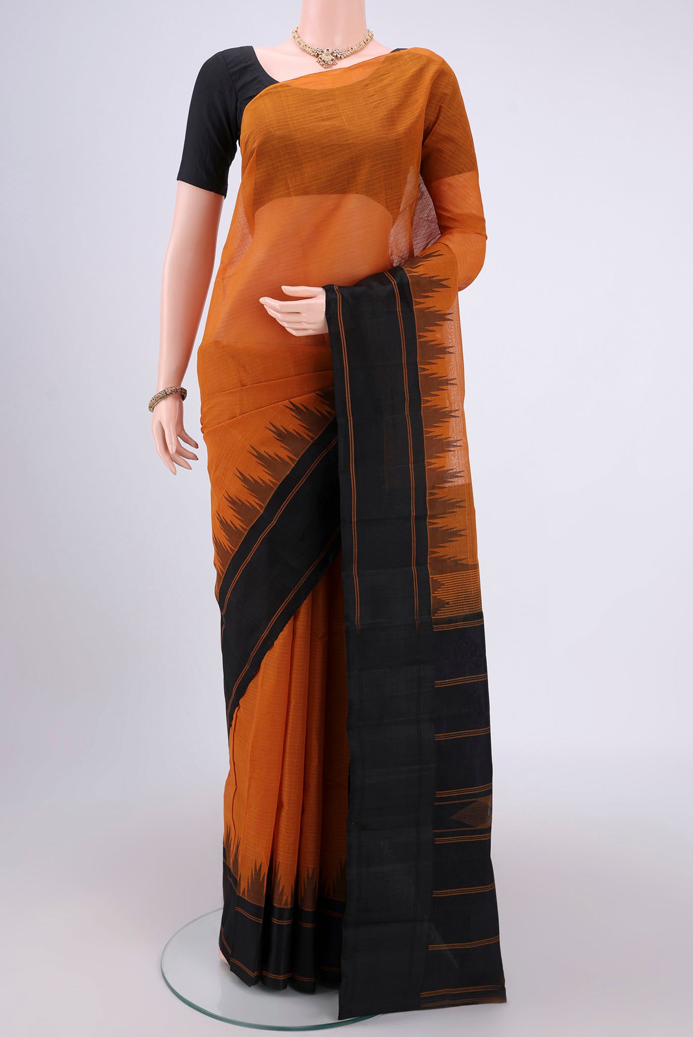 Mustard Kanchi Cotton Saree with Checked design on the body and Zari Border.  displayed on a mannequin