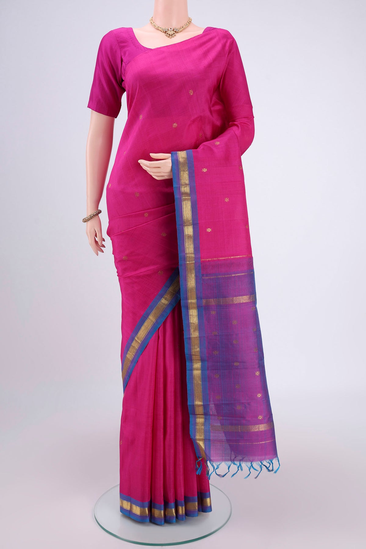 Rani Pink Kanjivaram Silk Saree with Zari Butta on the body and Zari Border.  displayed on a mannequin