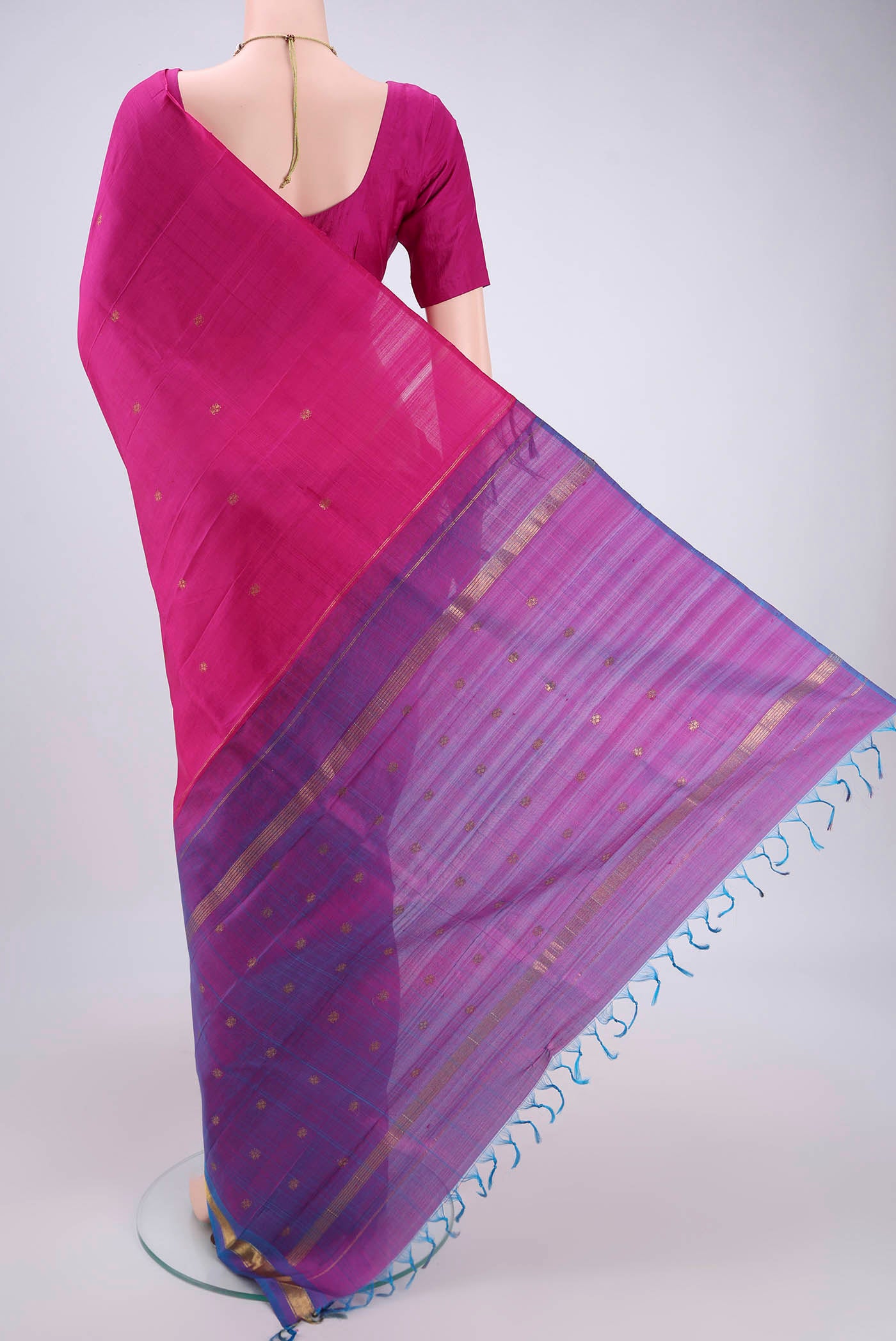 Flat view of Rani Pink Kanjivaram Silk Saree with Zari Butta on the body and Zari Border. 