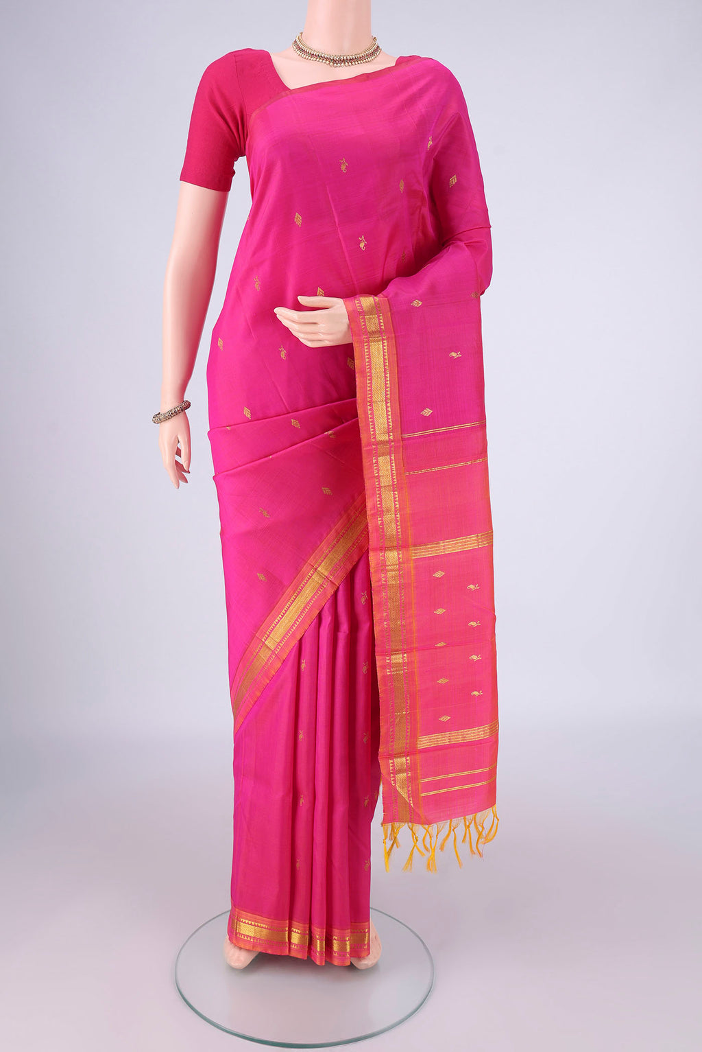Pink Kanjivaram Silk Saree with Zari Butta on the body and One Side Border.  displayed on a mannequin