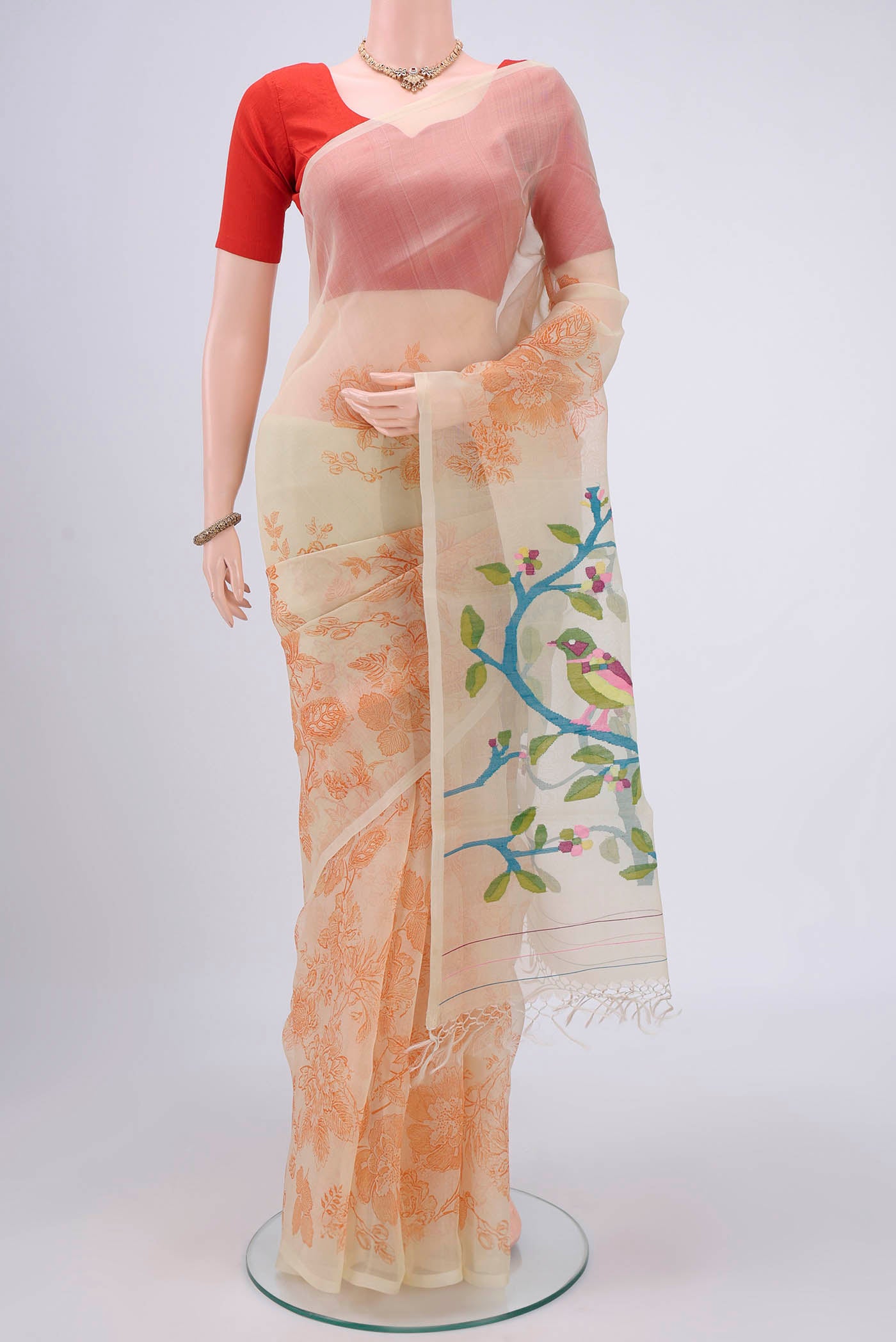Cream Organza Silk Saree with Printed design on the body and Without Border.  displayed on a mannequin
