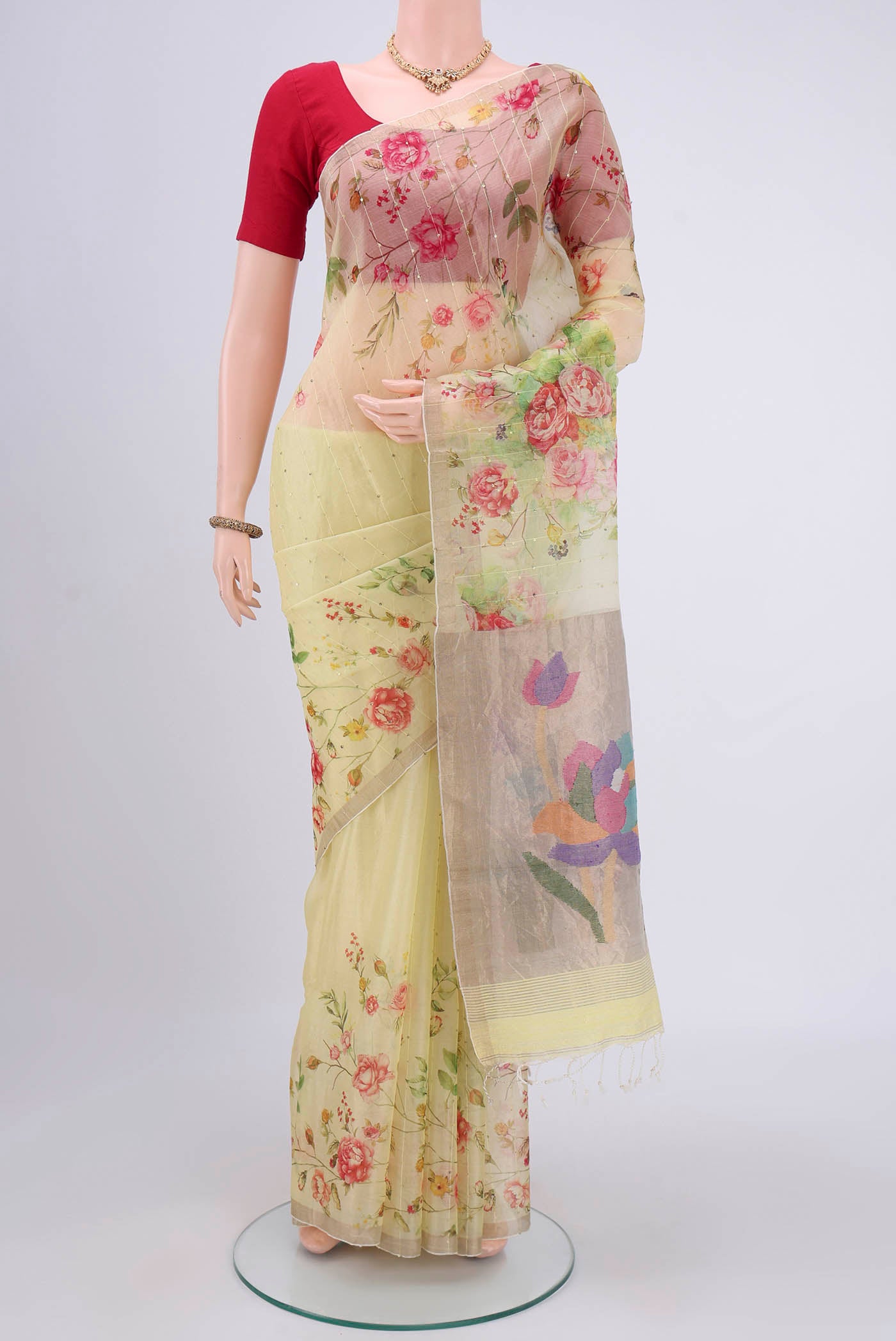 Lemon Yellow Organza Silk Saree with Printed design on the body and Zari Border.  displayed on a mannequin