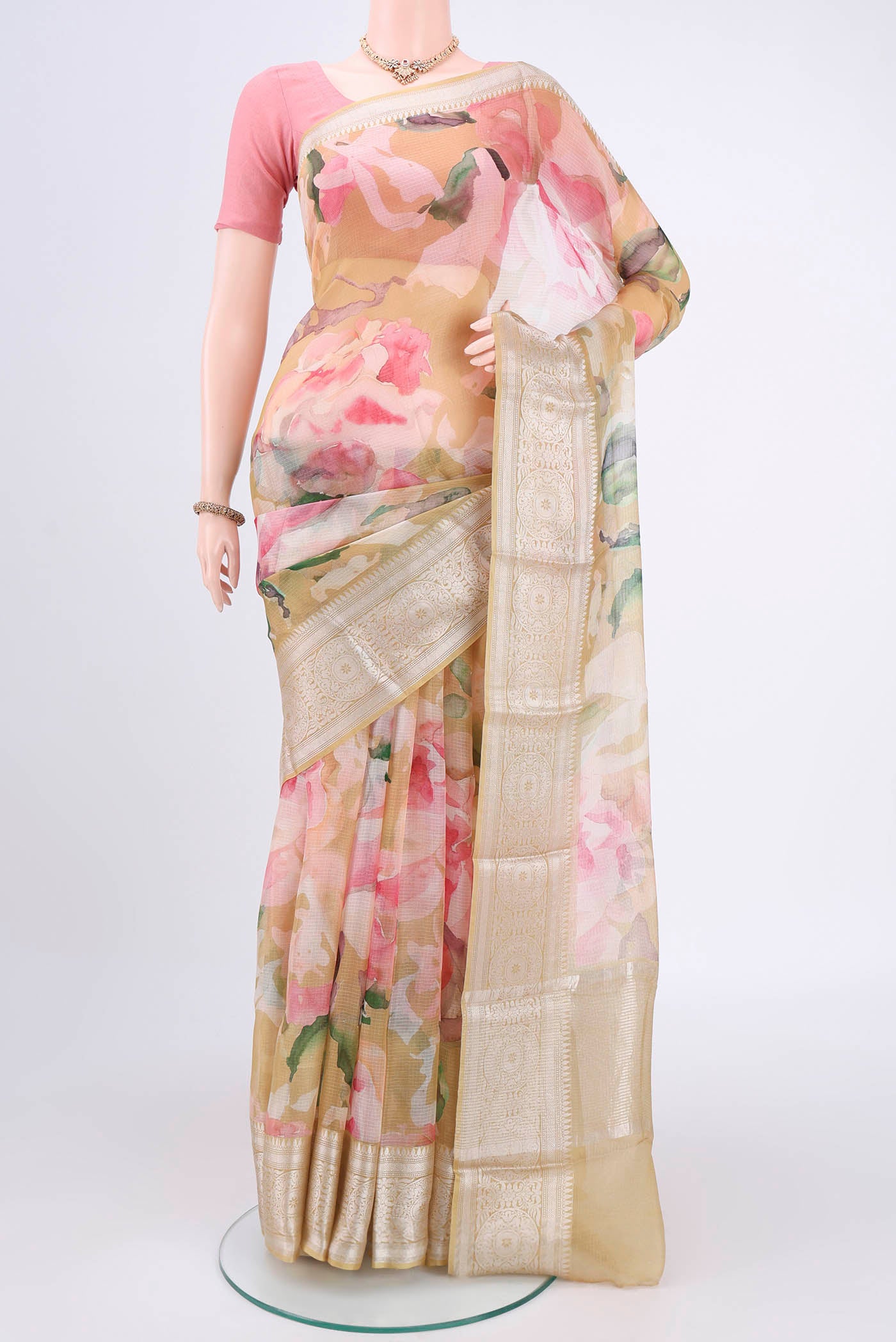 Mustard Kota Silk Saree with Printed design on the body and Zari Border.  displayed on a mannequin