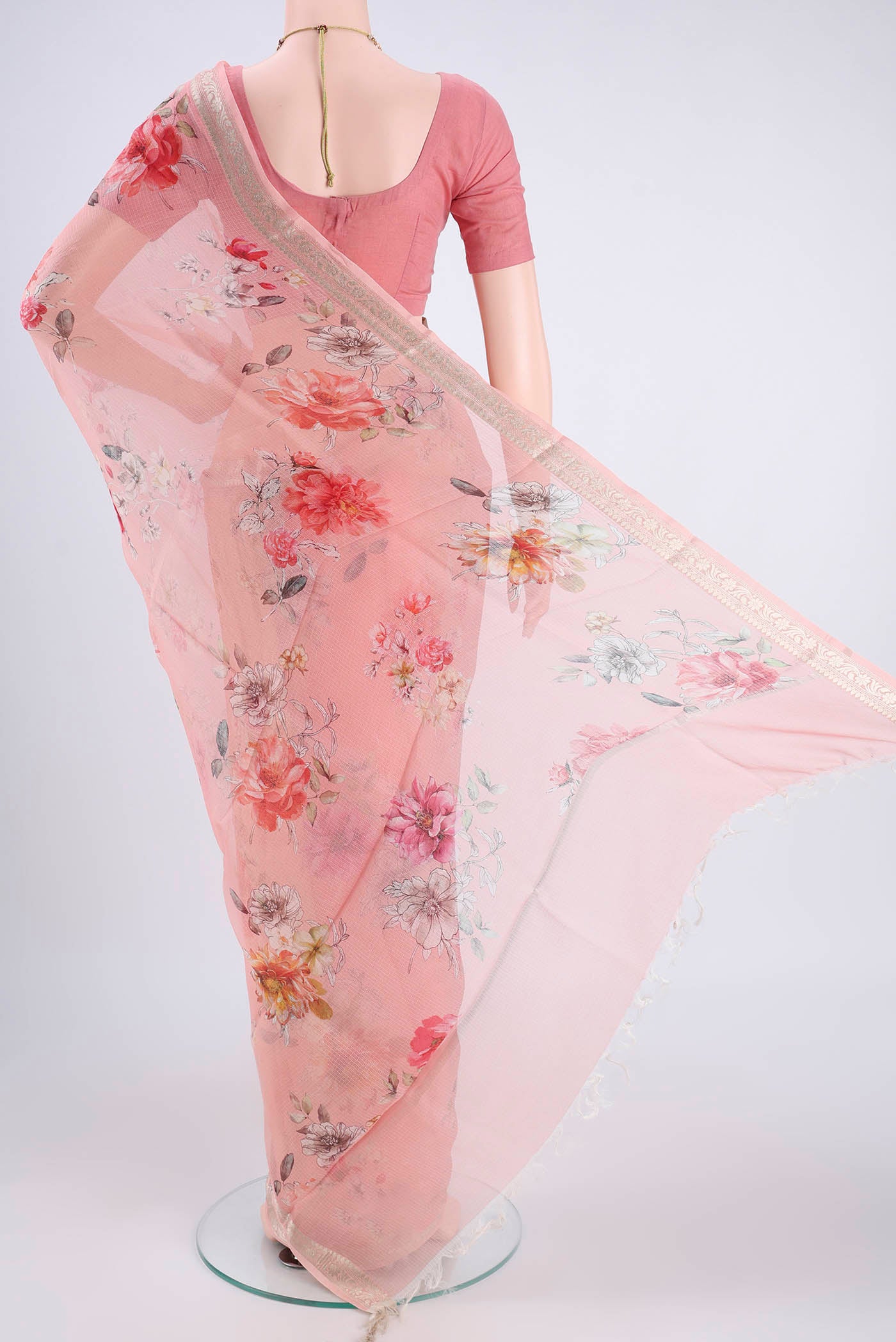 Flat view of Peach Kota Silk Saree with Printed design on the body and Zari Border. 