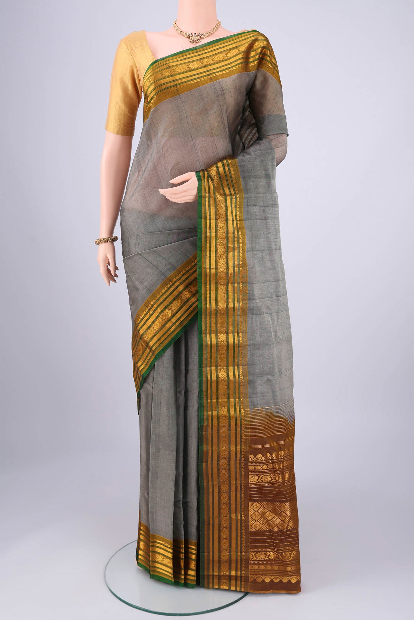 Grey Gadwal cotton Saree with Plain Body and Zari Border.  displayed on a mannequin