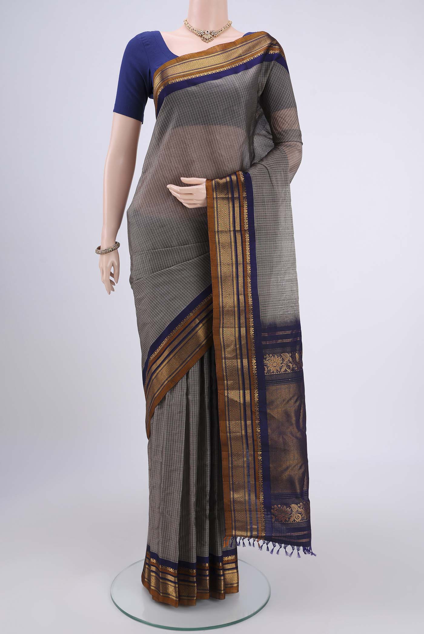 Grey Gadwal Silk Cotton Saree with Checked design on the body and Zari Border.  displayed on a mannequin