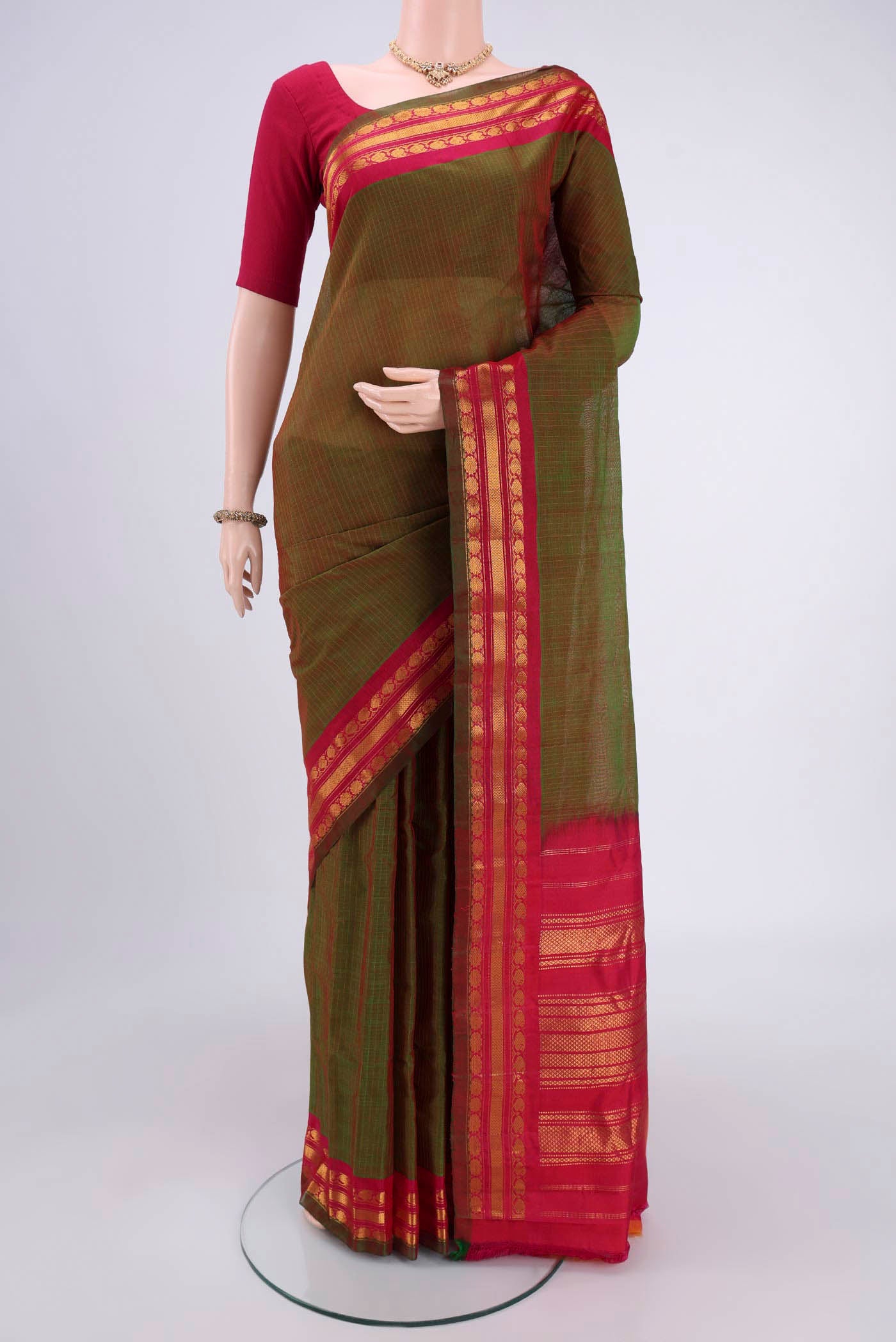 Light Green Dual Tone Gadwal Silk Cotton Saree with Checked design on the body and Silk Border.  displayed on a mannequin