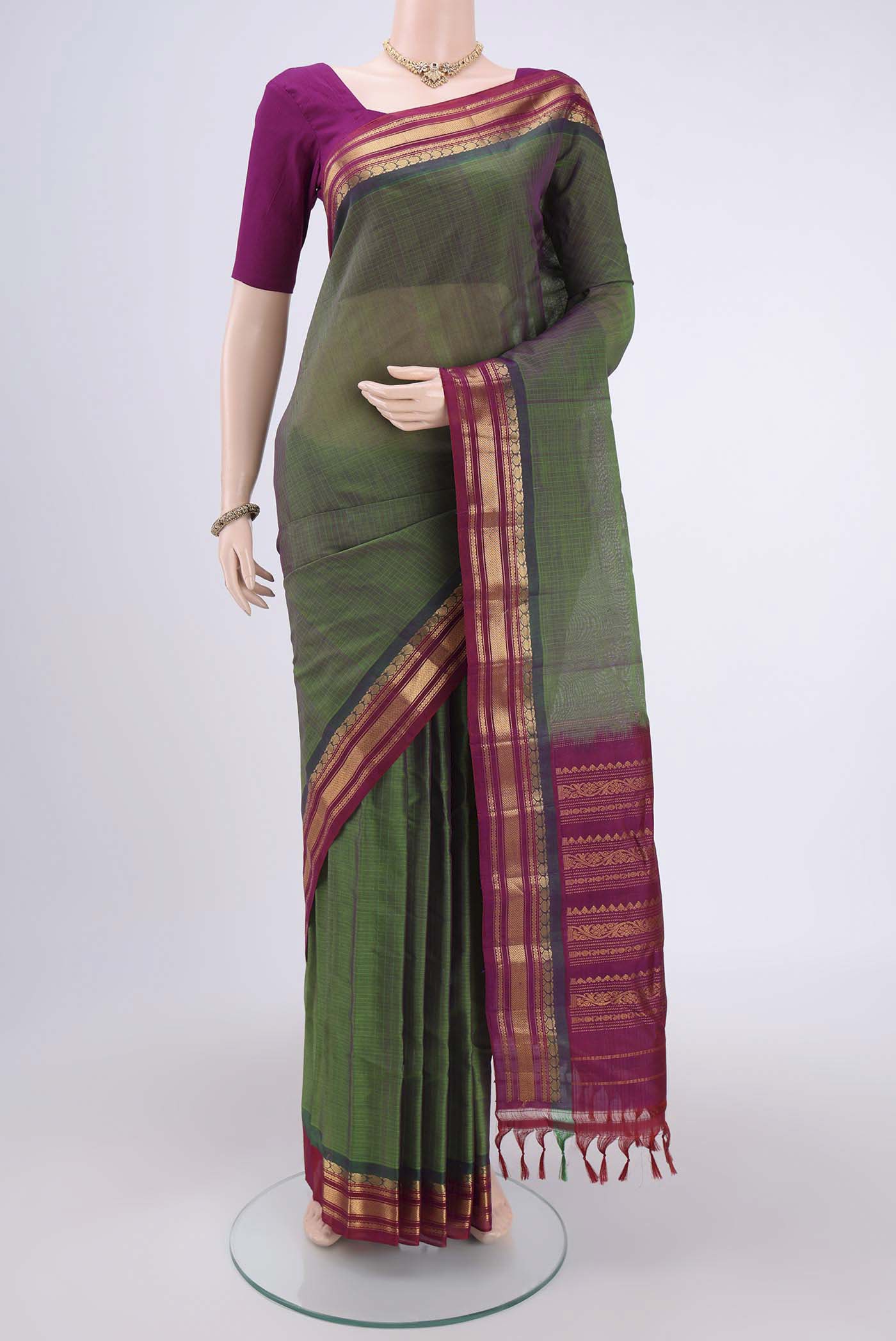 Green Gadwal Silk Cotton Saree with Stripes on the body and Silk Border.  displayed on a mannequin