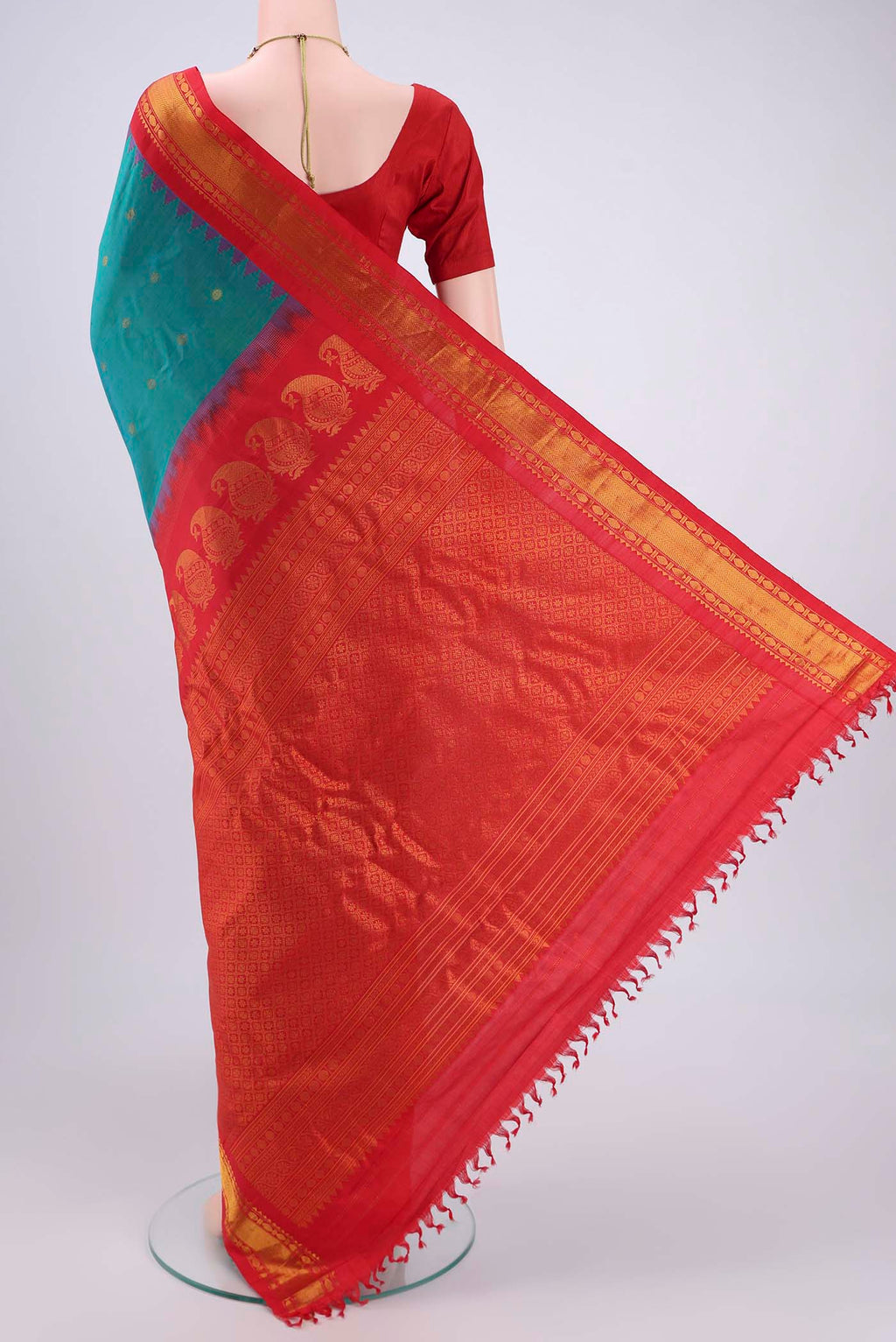 Flat view of Sea Green Dual Tone Gadwal Silk Saree with Zari Butta on the body and Zari Border. 