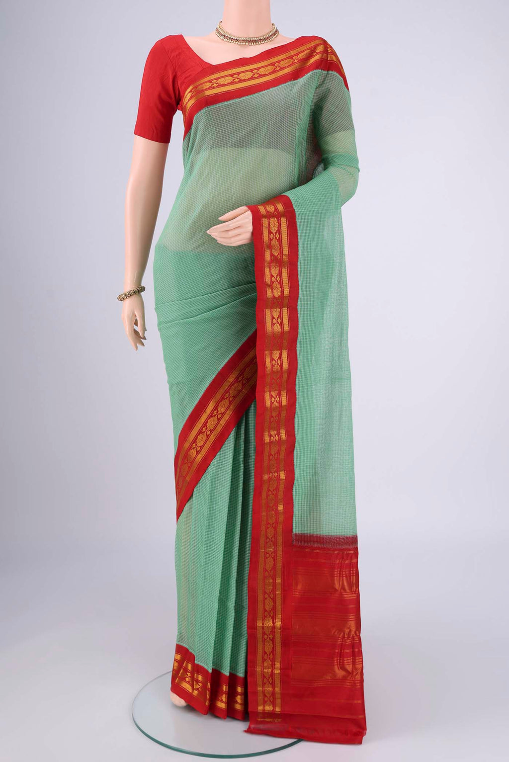 Green Gadwal cotton Saree with Checked design on the body and Zari Border.  displayed on a mannequin