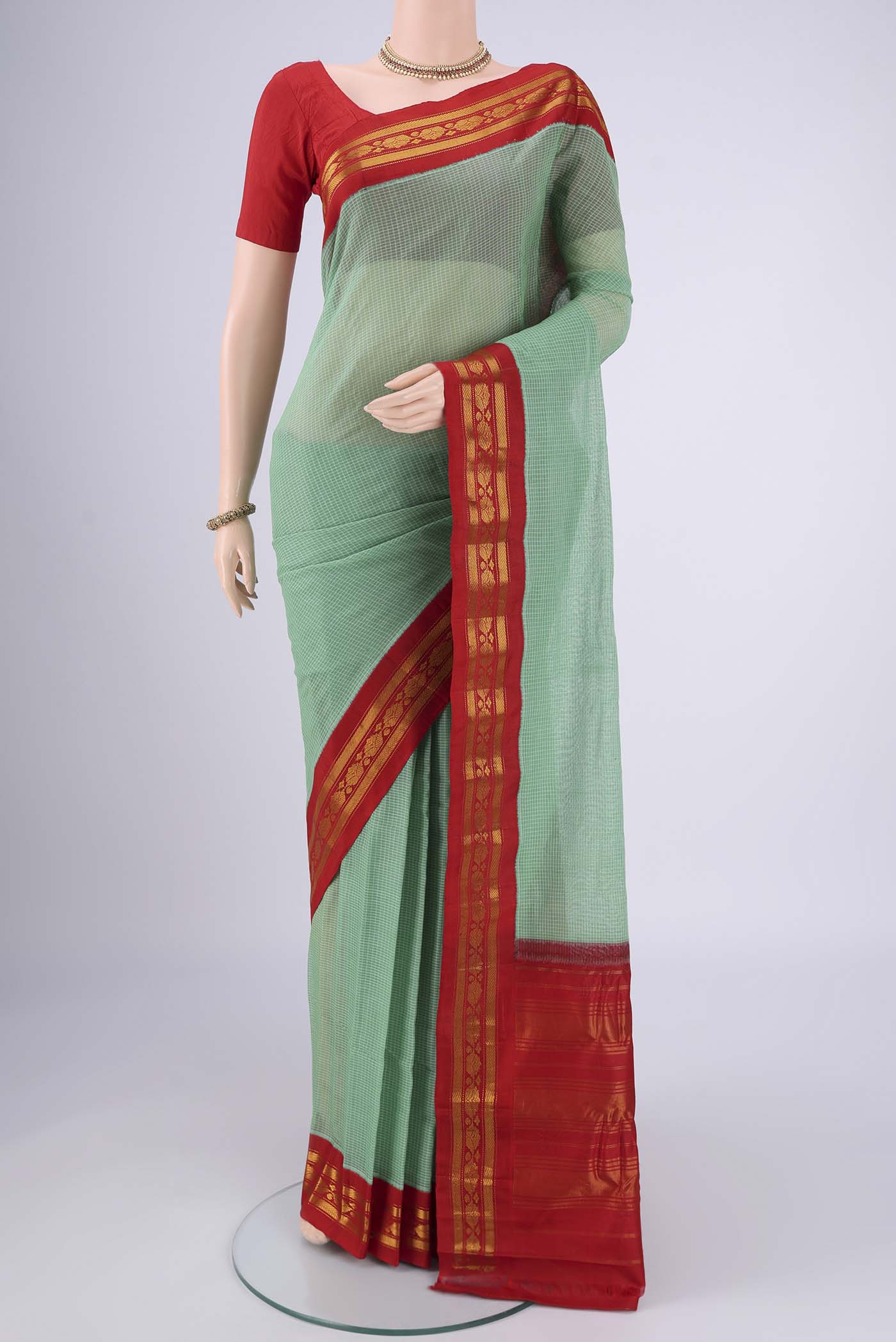 Green Gadwal cotton Saree with Checked design on the body and Zari Border.  displayed on a mannequin