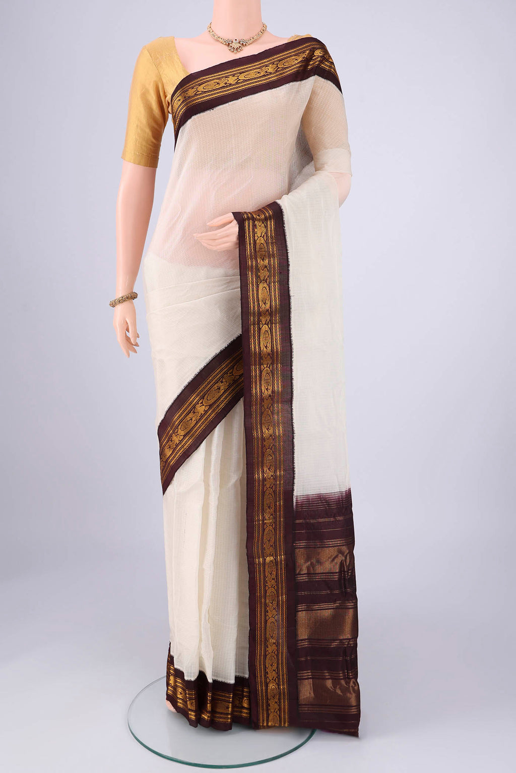 Off White Gadwal cotton Saree with Checked design on the body and Zari Border.  displayed on a mannequin