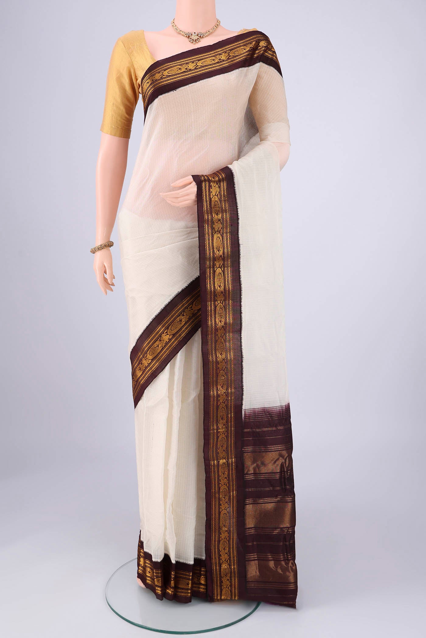Off White Gadwal cotton Saree with Checked design on the body and Zari Border.  displayed on a mannequin