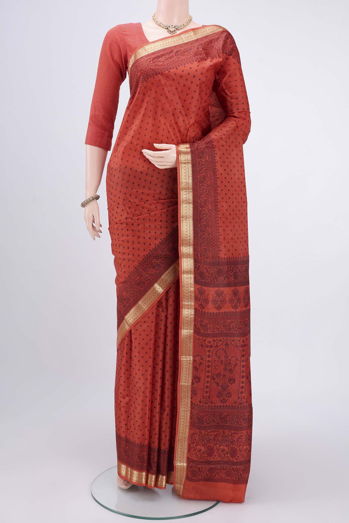 Imperial Red Printed Silk Saree with Printed design on the body and Zari Border.  displayed on a mannequin