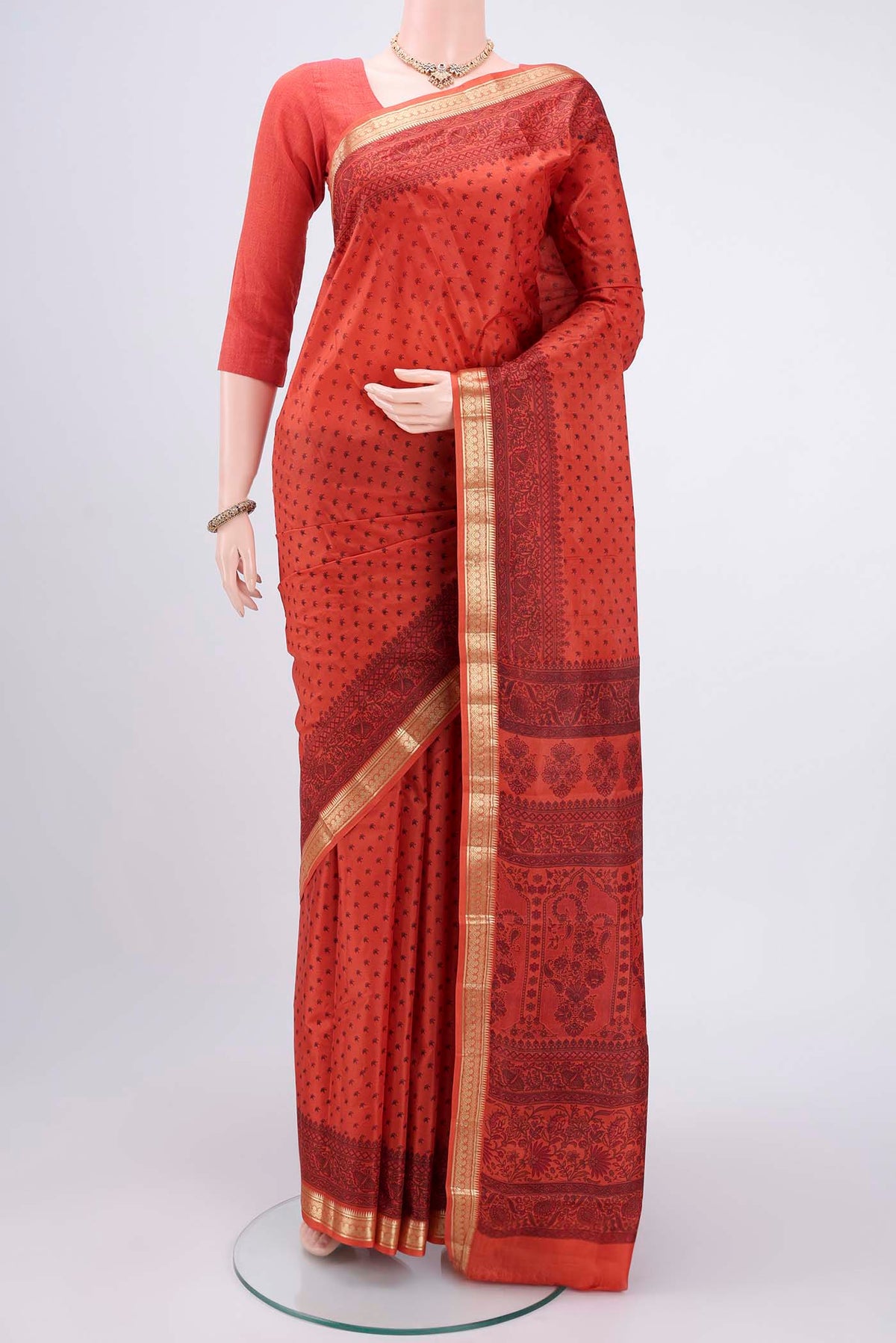 Imperial Red Printed Silk Saree with Printed design on the body and Zari Border.  displayed on a mannequin
