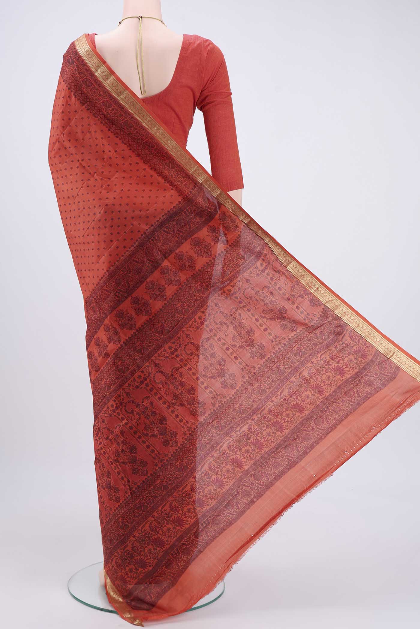 Flat view of Imperial Red Printed Silk Saree with Printed design on the body and Zari Border. 