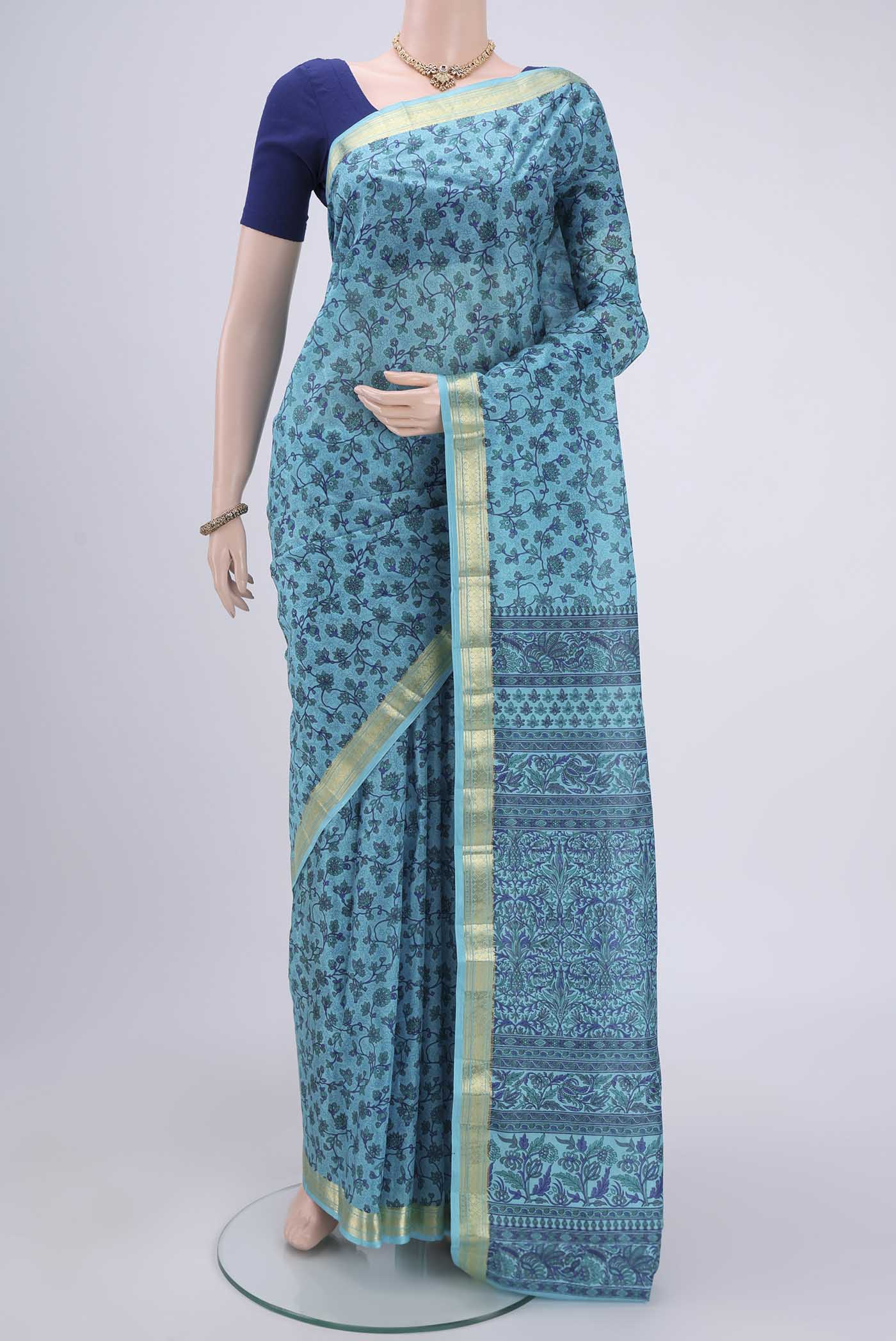 Sky Blue Printed Silk Saree with Printed design on the body and Zari Border.  displayed on a mannequin