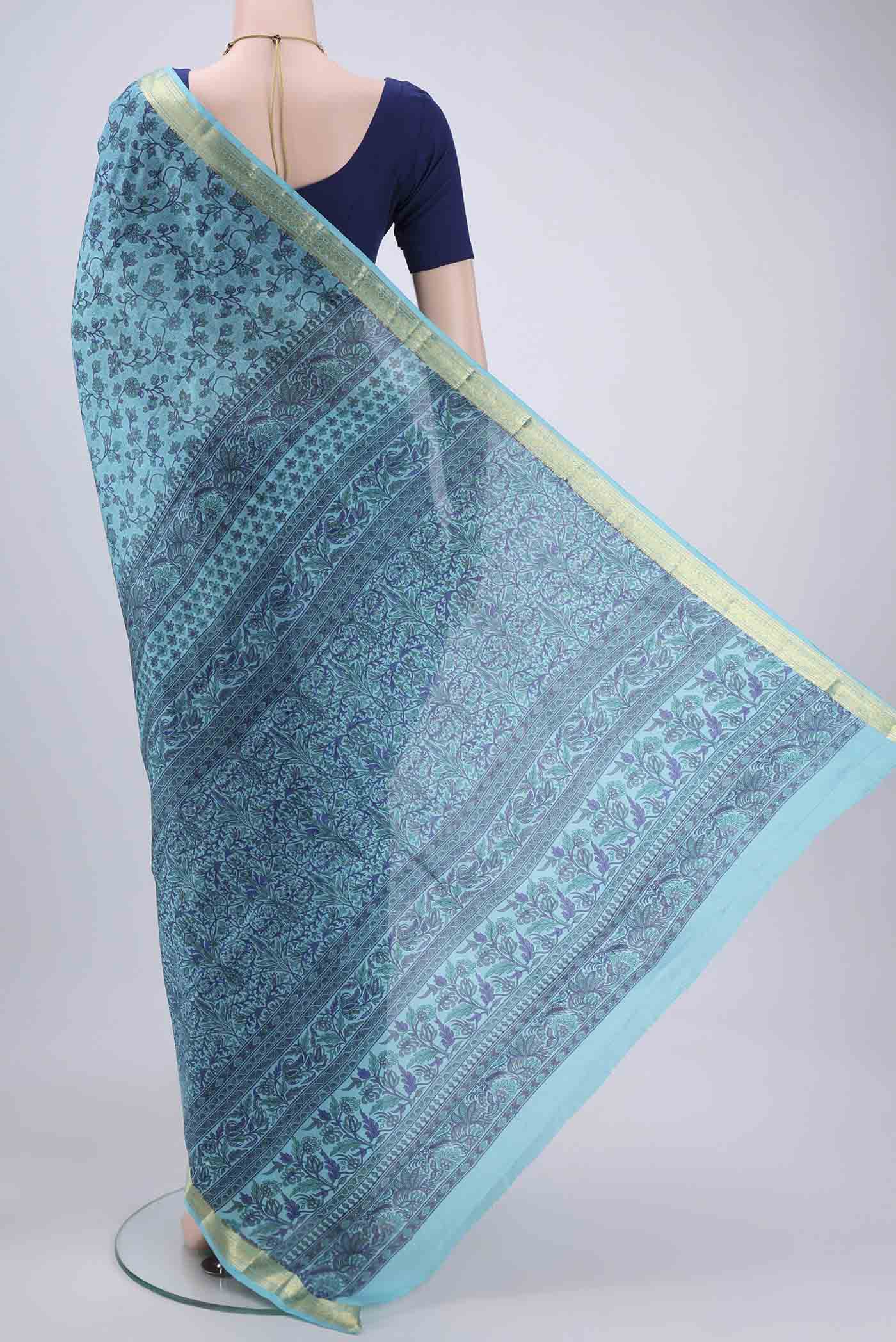 Flat view of Sky Blue Printed Silk Saree with Printed design on the body and Zari Border. 