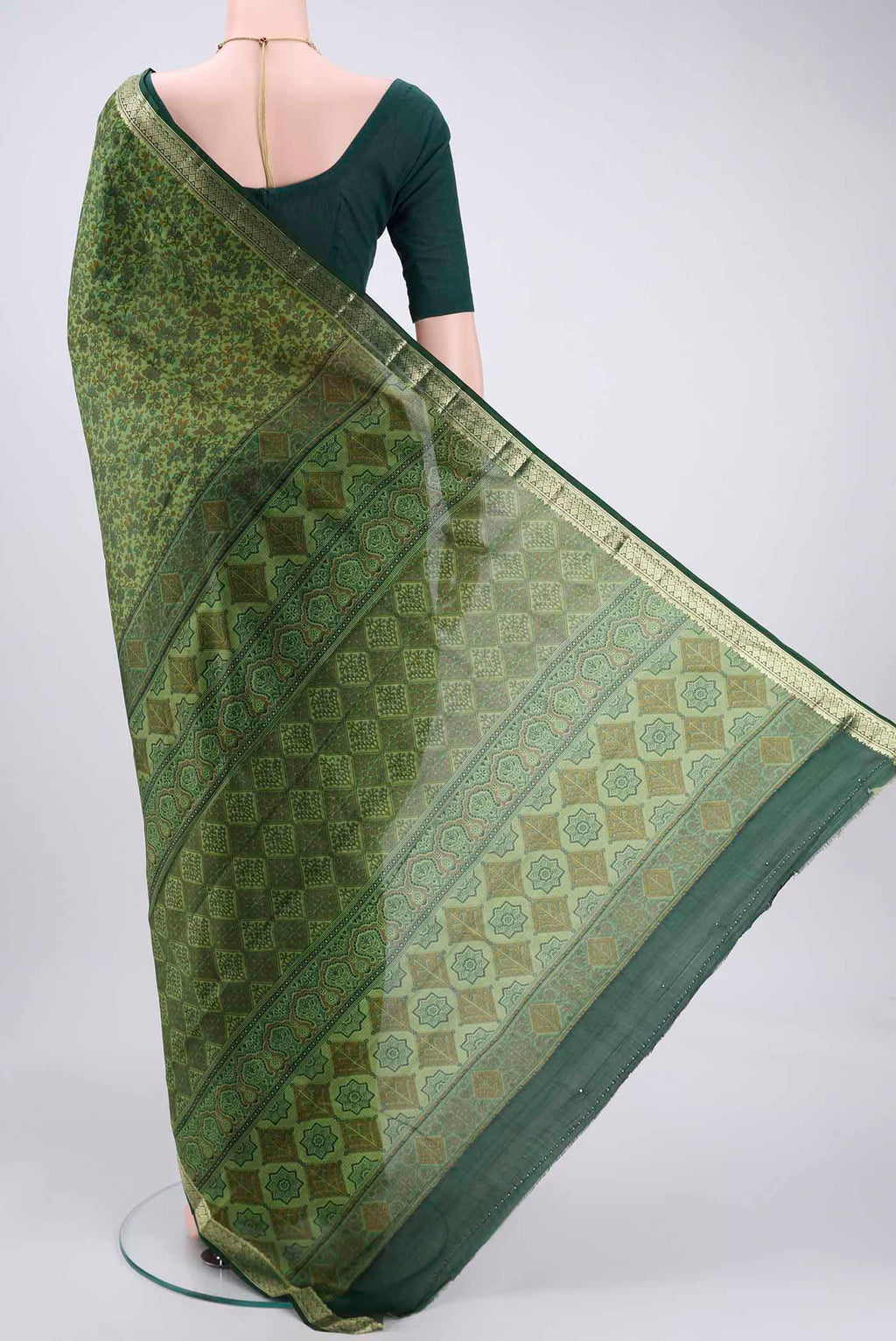 Flat view of Light Green Printed Silk Saree with Printed design on the body and Zari Border. 