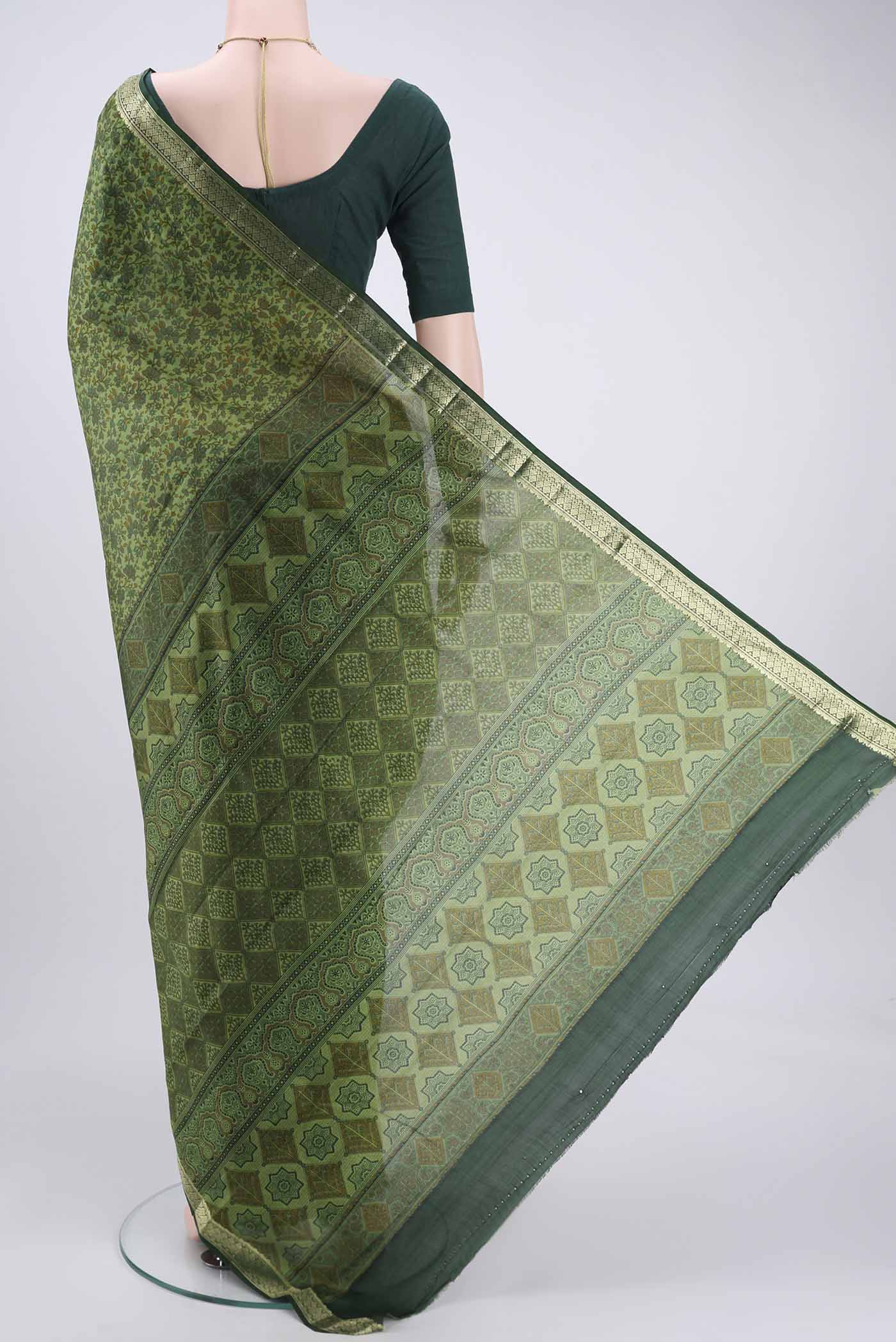 Flat view of Light Green Printed Silk Saree with Printed design on the body and Zari Border. 