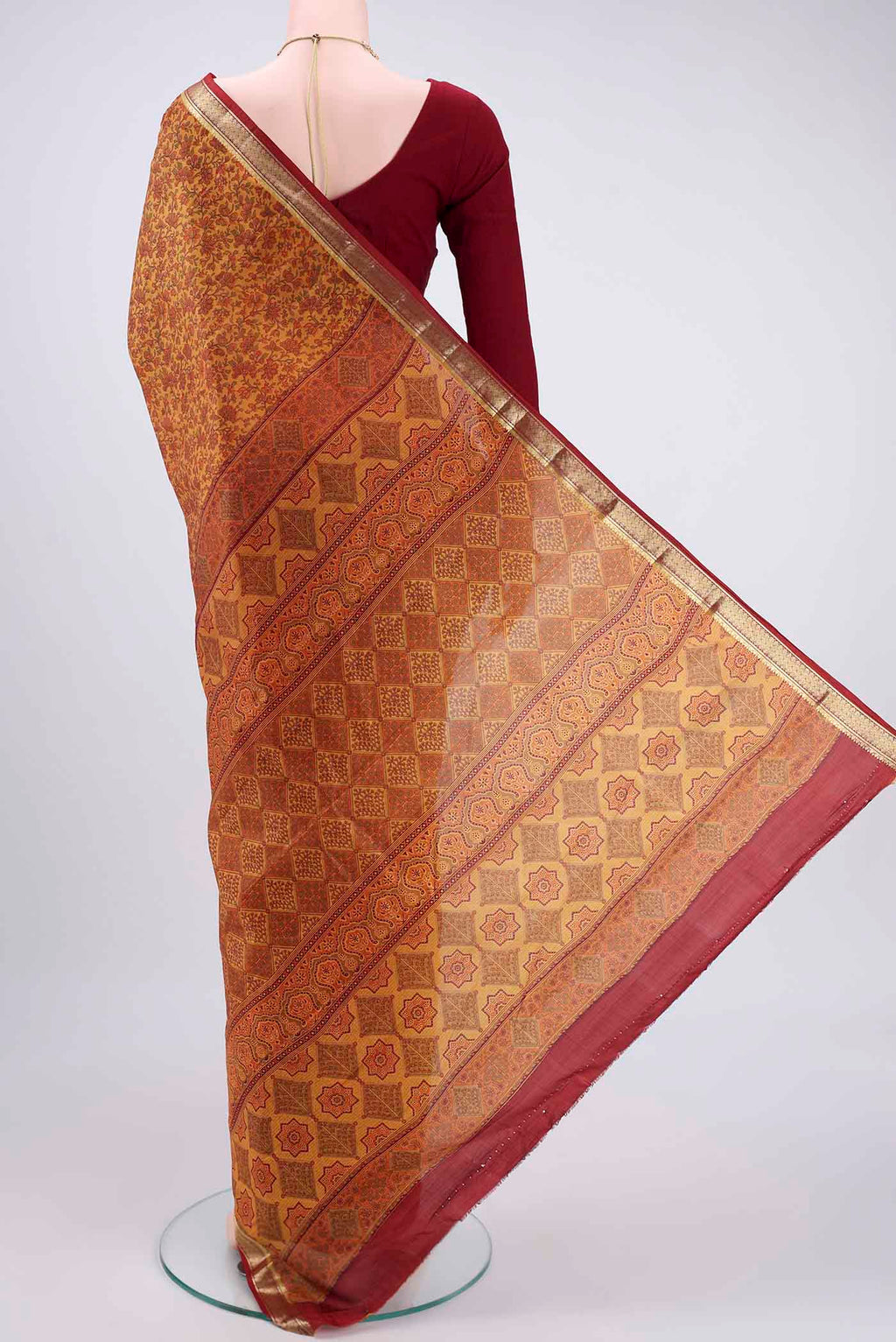 Flat view of Mustard Printed Silk Saree with Printed design on the body and Zari Border. 