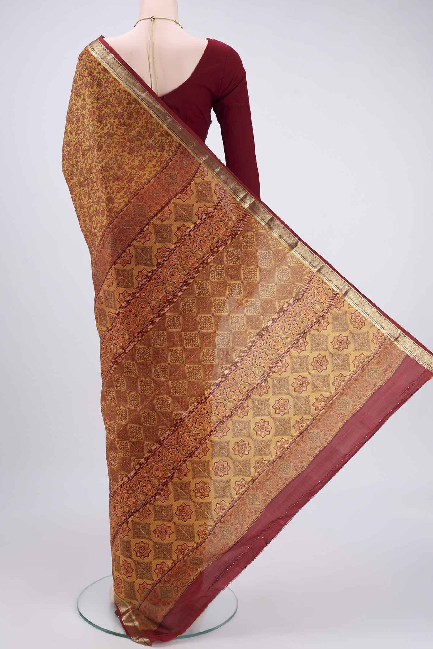 Flat view of Mustard Printed Silk Saree with Printed design on the body and Zari Border. 