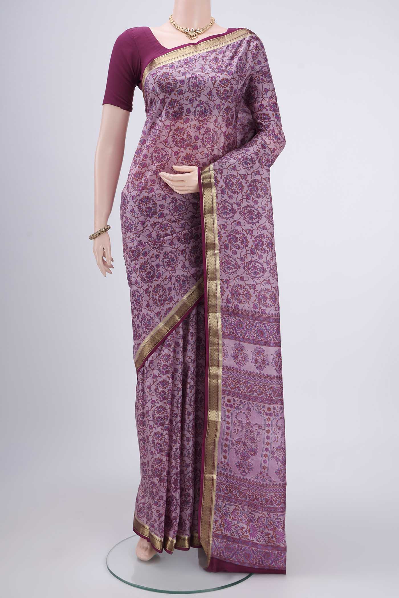 Purple Printed Silk Saree with Printed design on the body and Zari Border.  displayed on a mannequin
