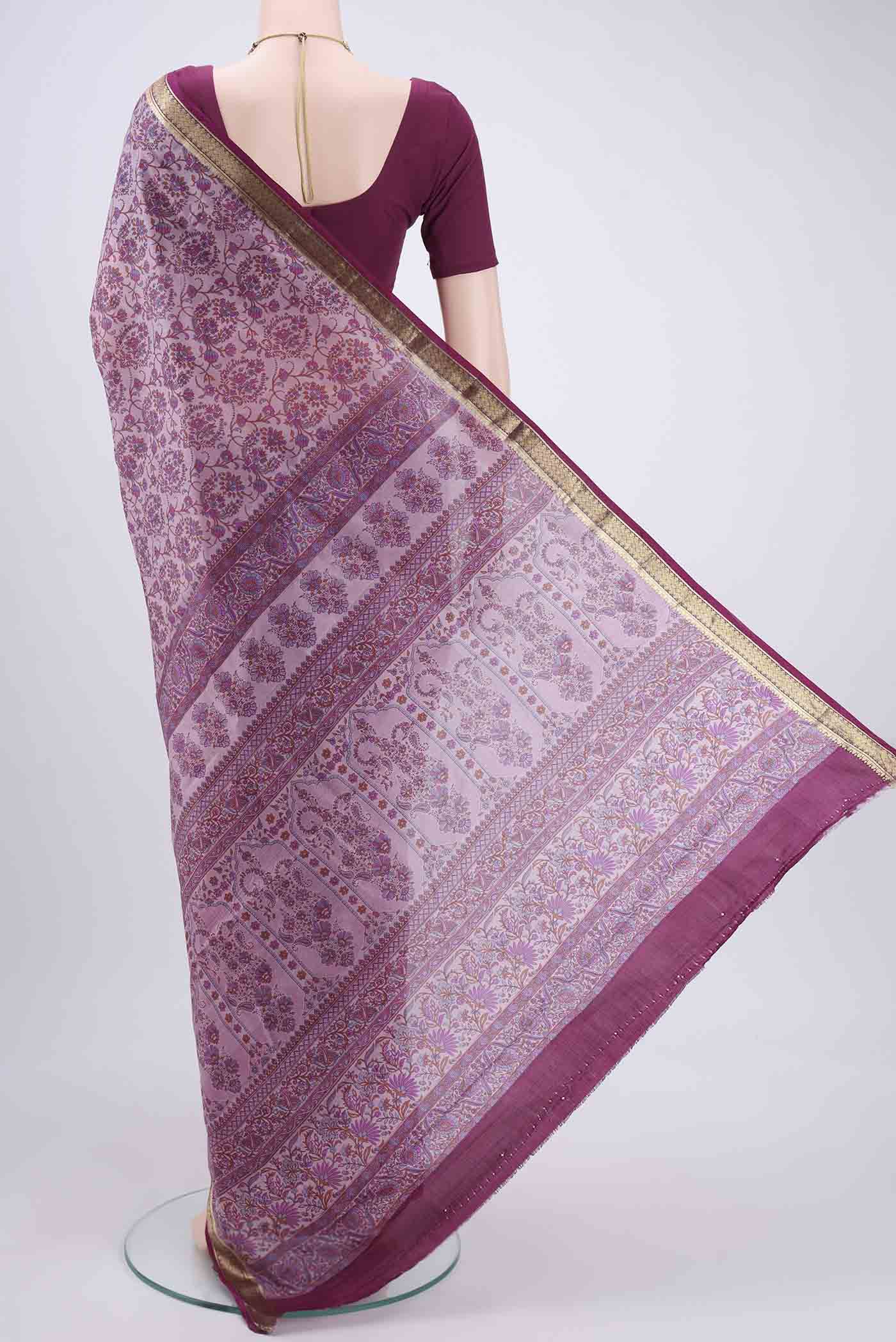 Flat view of Purple Printed Silk Saree with Printed design on the body and Zari Border. 