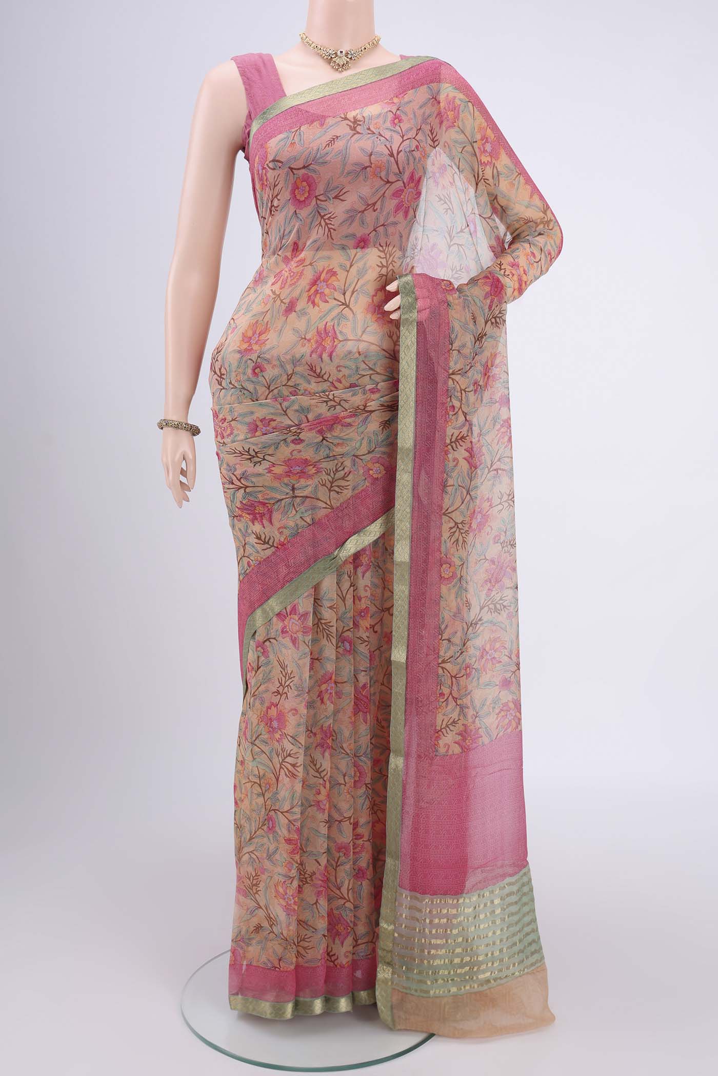Peach Mysore Chiffon Saree with Floral Print on the body and Satin Border.  displayed on a mannequin