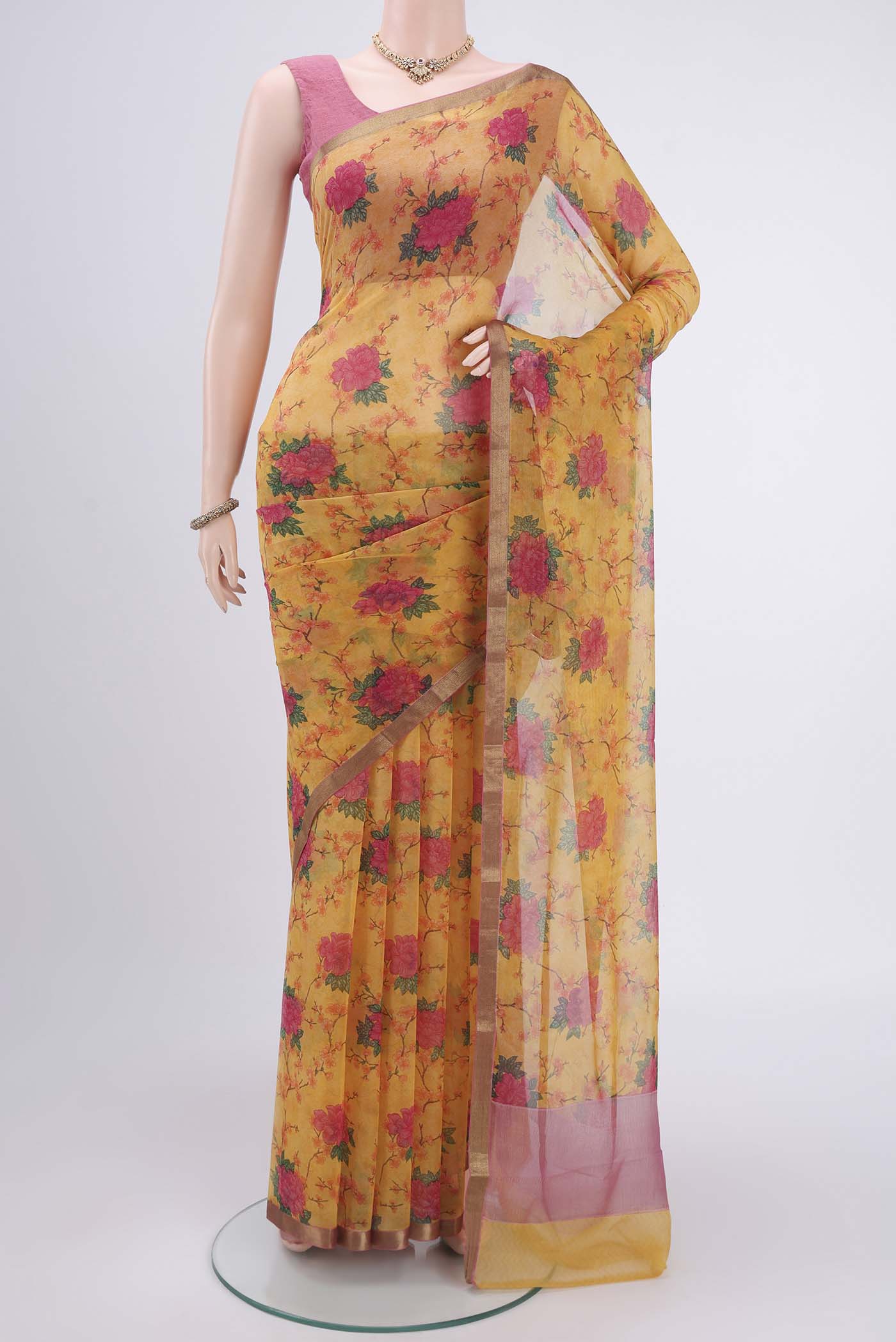 Mustard Mysore Chiffon Saree with Floral Print on the body and Zari Border.  displayed on a mannequin