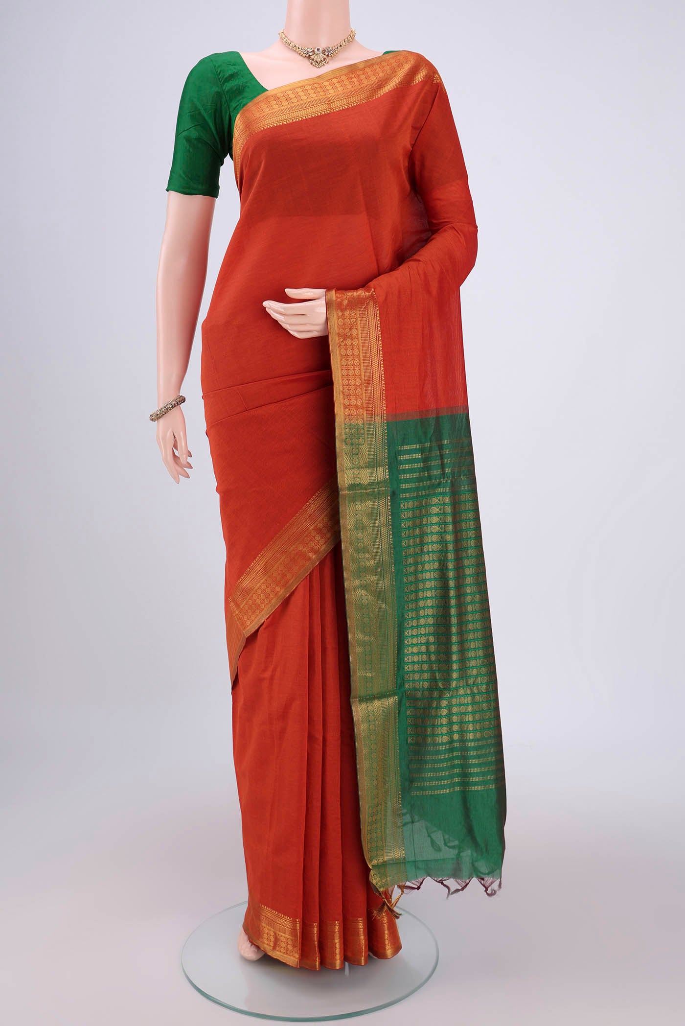 Rust Blended Poly Cotton Saree with Plain Body and Zari Border.  displayed on a mannequin