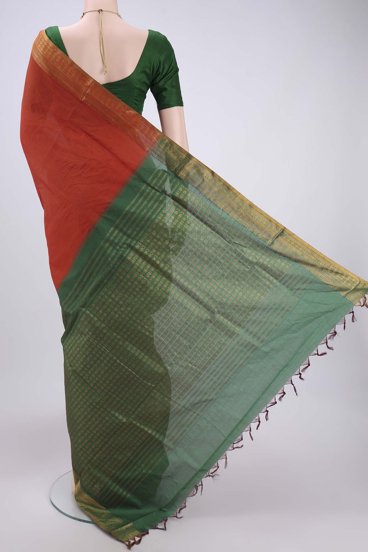Flat view of Rust Blended Poly Cotton Saree with Plain Body and Zari Border. 