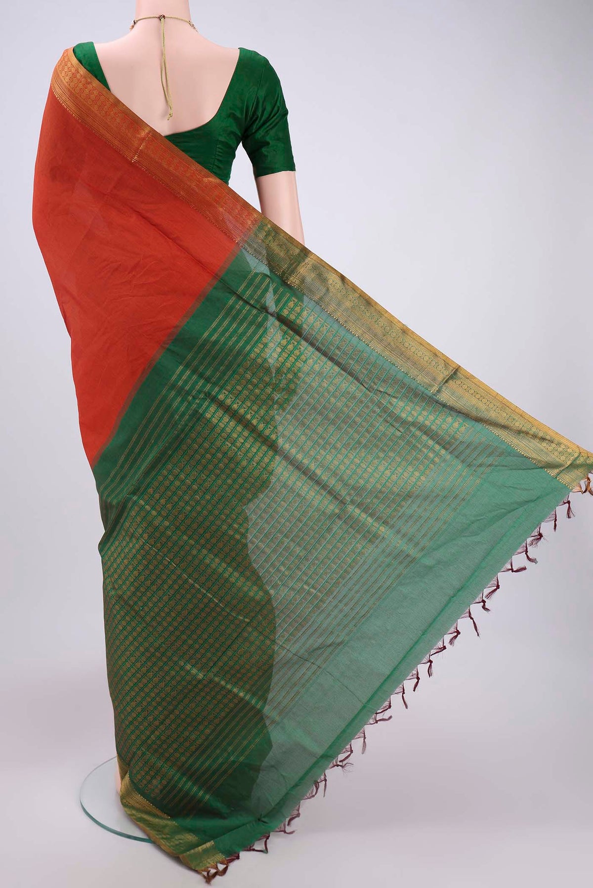 Flat view of Rust Blended Poly Cotton Saree with Plain Body and Zari Border. 