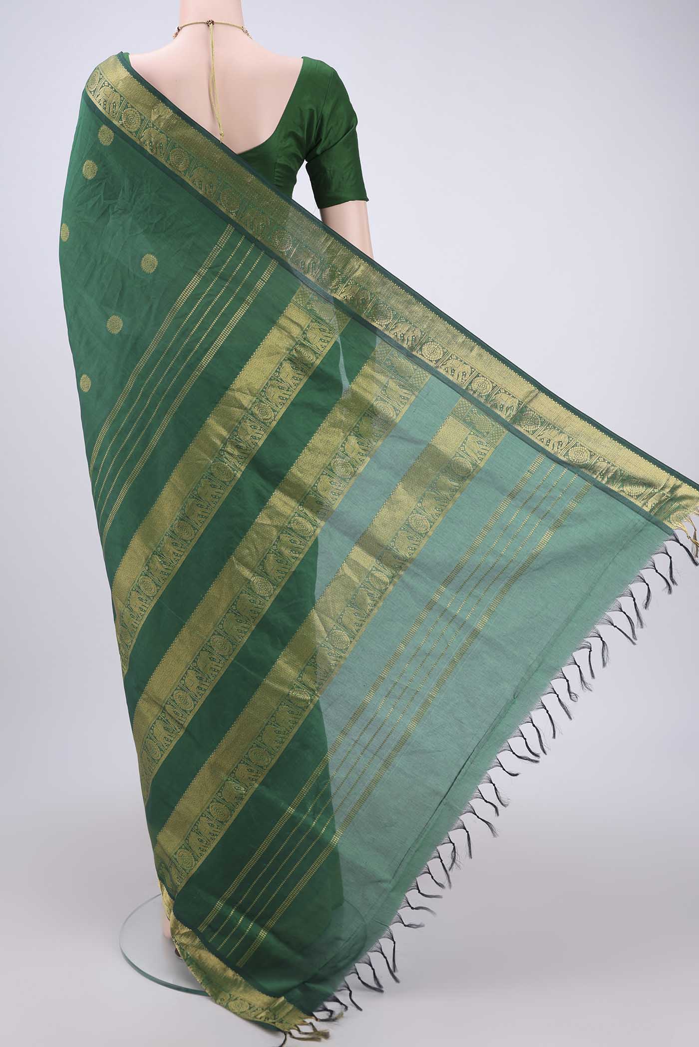 Flat view of Bottle Green Blended Poly Cotton Saree with Zari Butta on the body and Zari Border. 