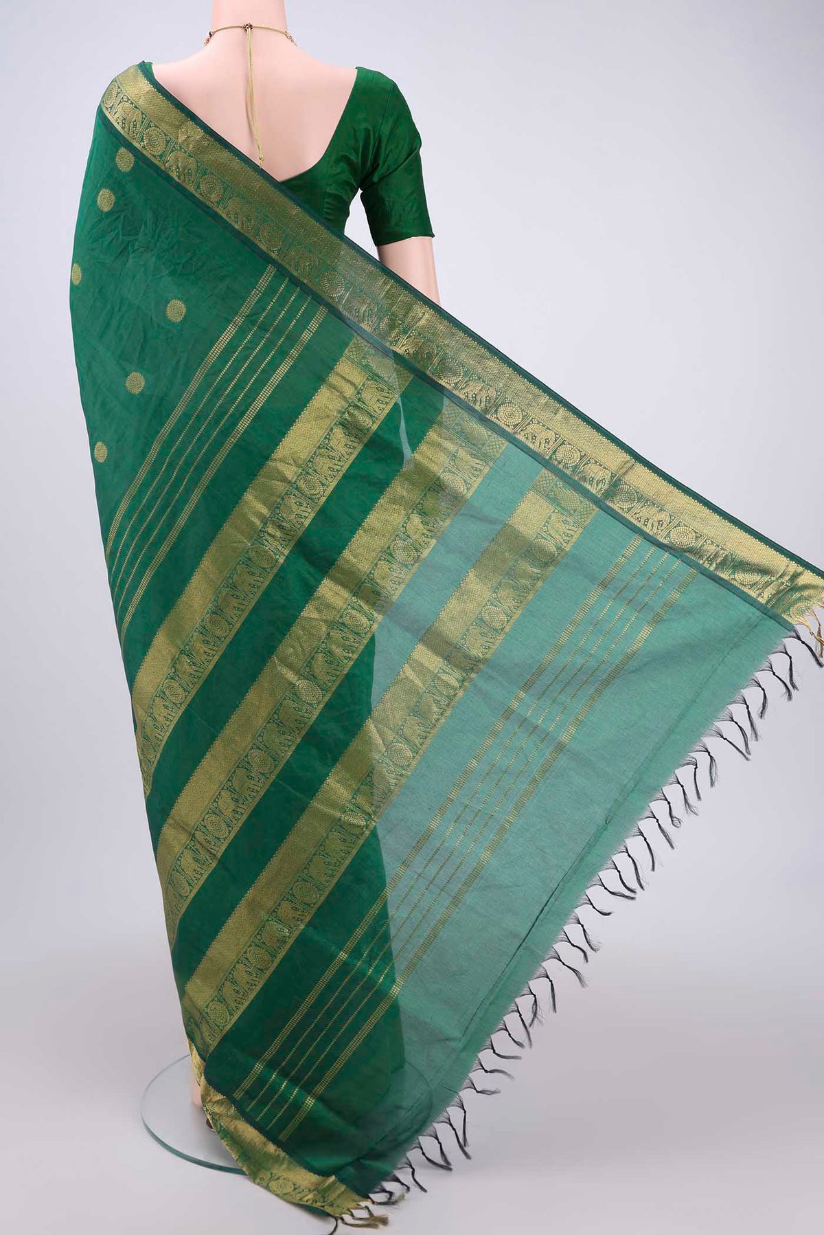 Flat view of Bottle Green Blended Poly Cotton Saree with Zari Butta on the body and Zari Border. 