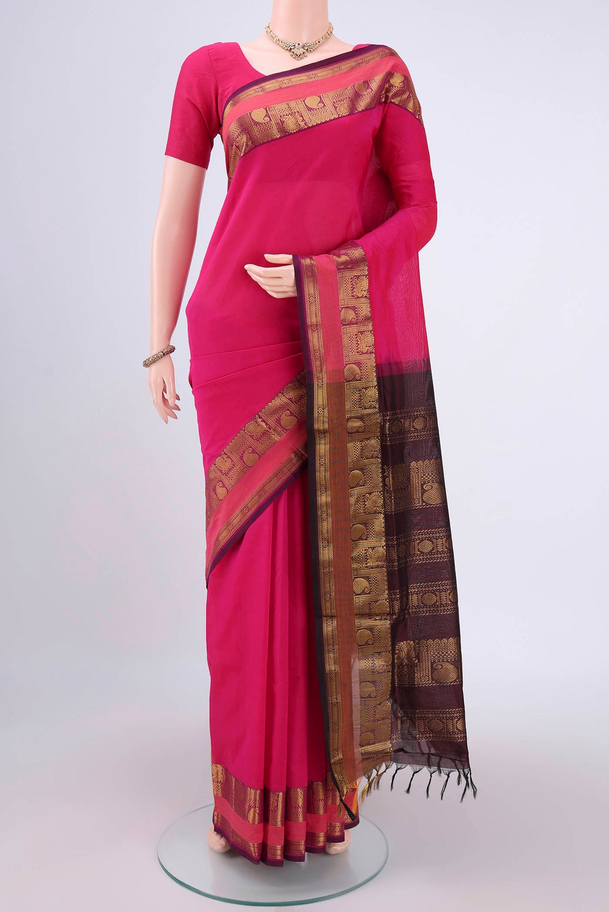 Rani Pink Blended Poly Cotton Saree with Plain Body and Zari Border.  displayed on a mannequin