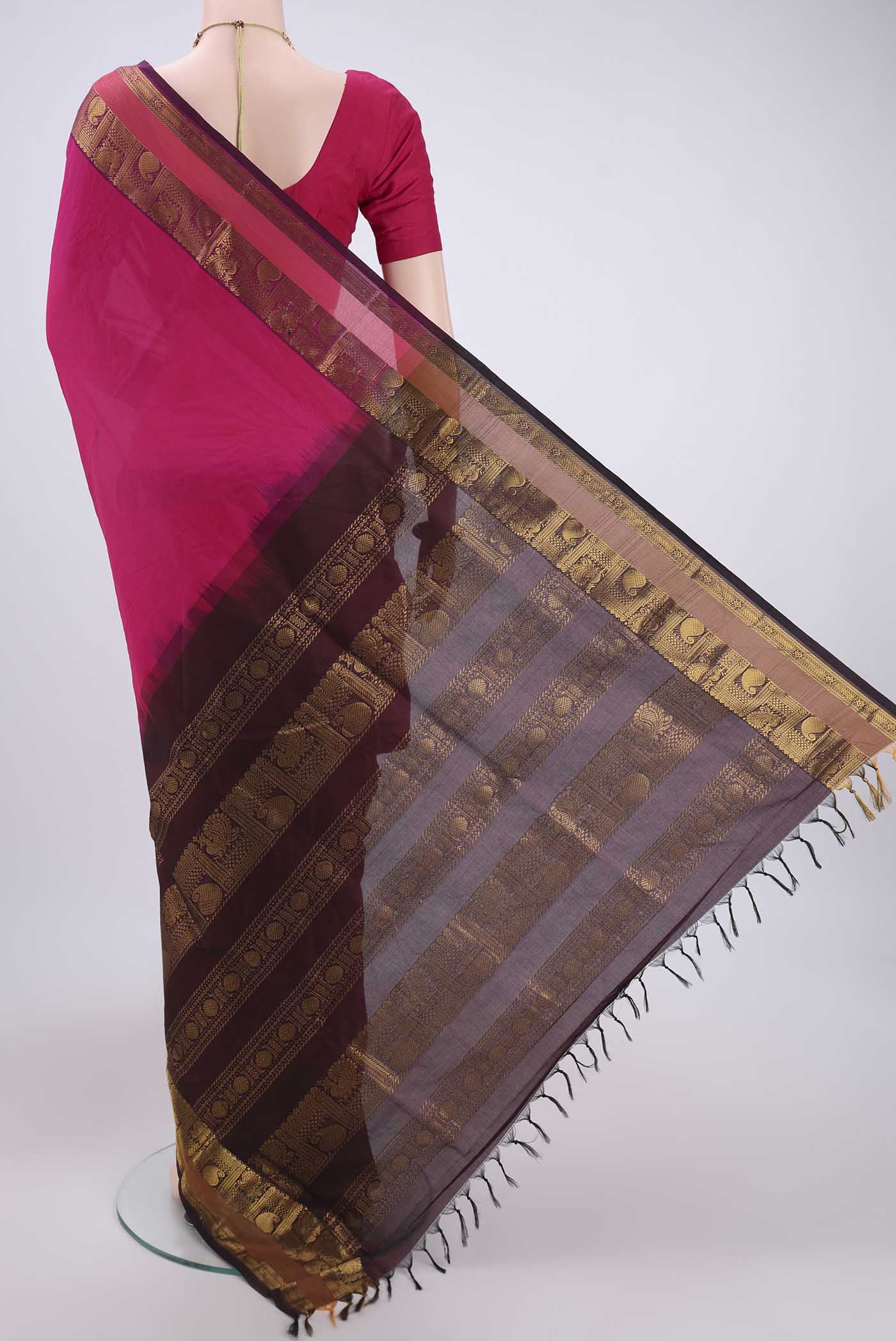 Flat view of Rani Pink Blended Poly Cotton Saree with Plain Body and Zari Border. 