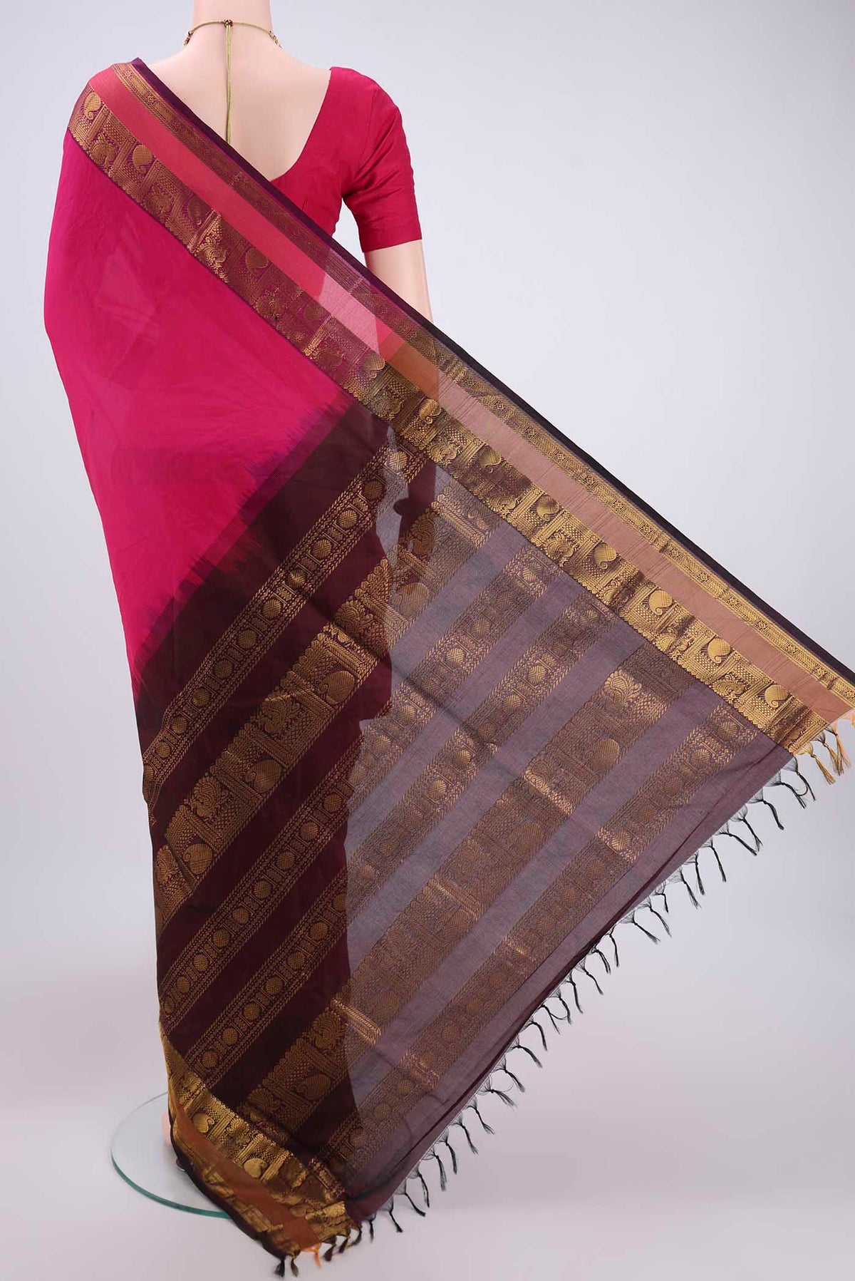 Flat view of Rani Pink Blended Poly Cotton Saree with Plain Body and Zari Border. 