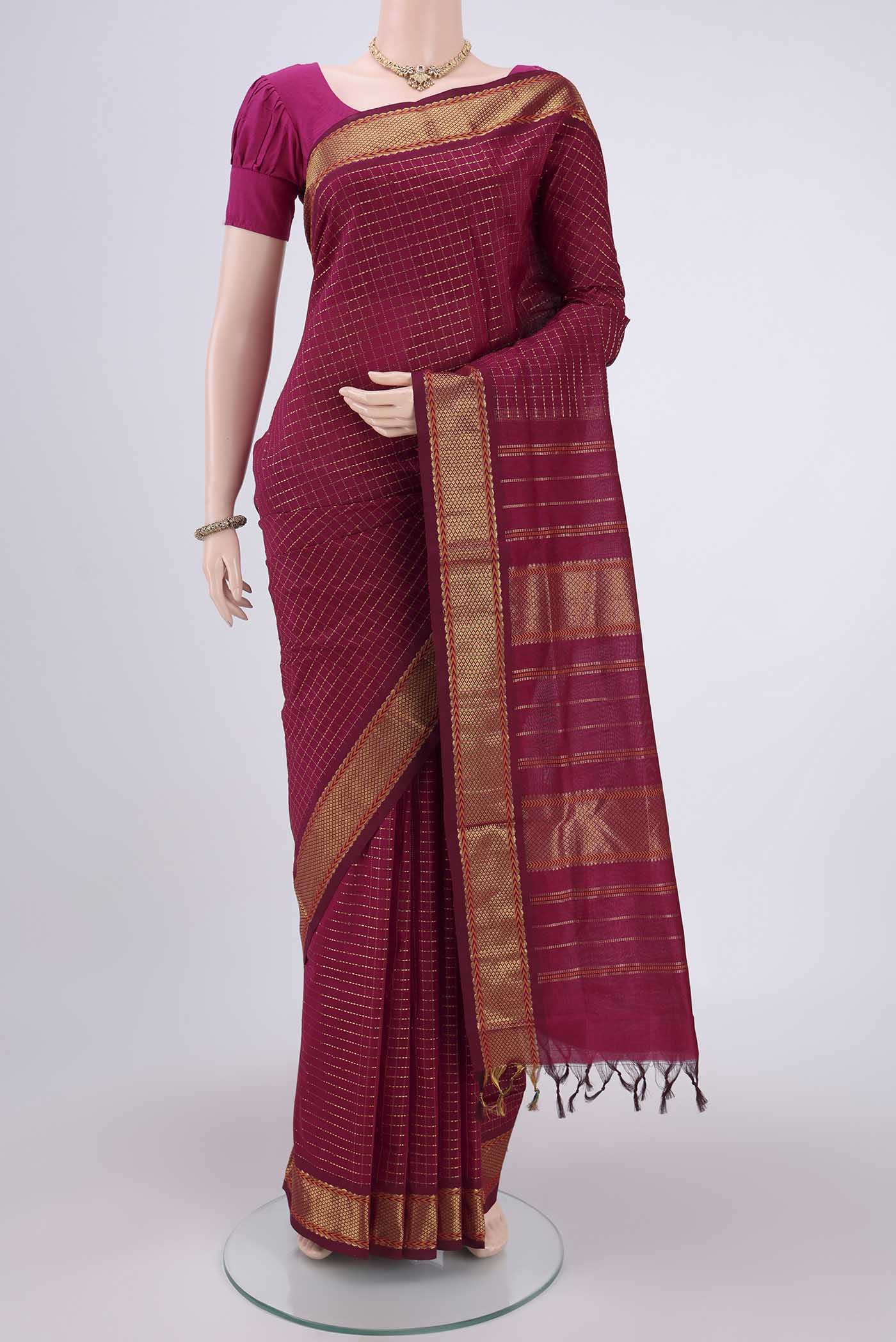 Magenta Blended Poly Cotton Saree with Checked design on the body and Zari Border.  displayed on a mannequin
