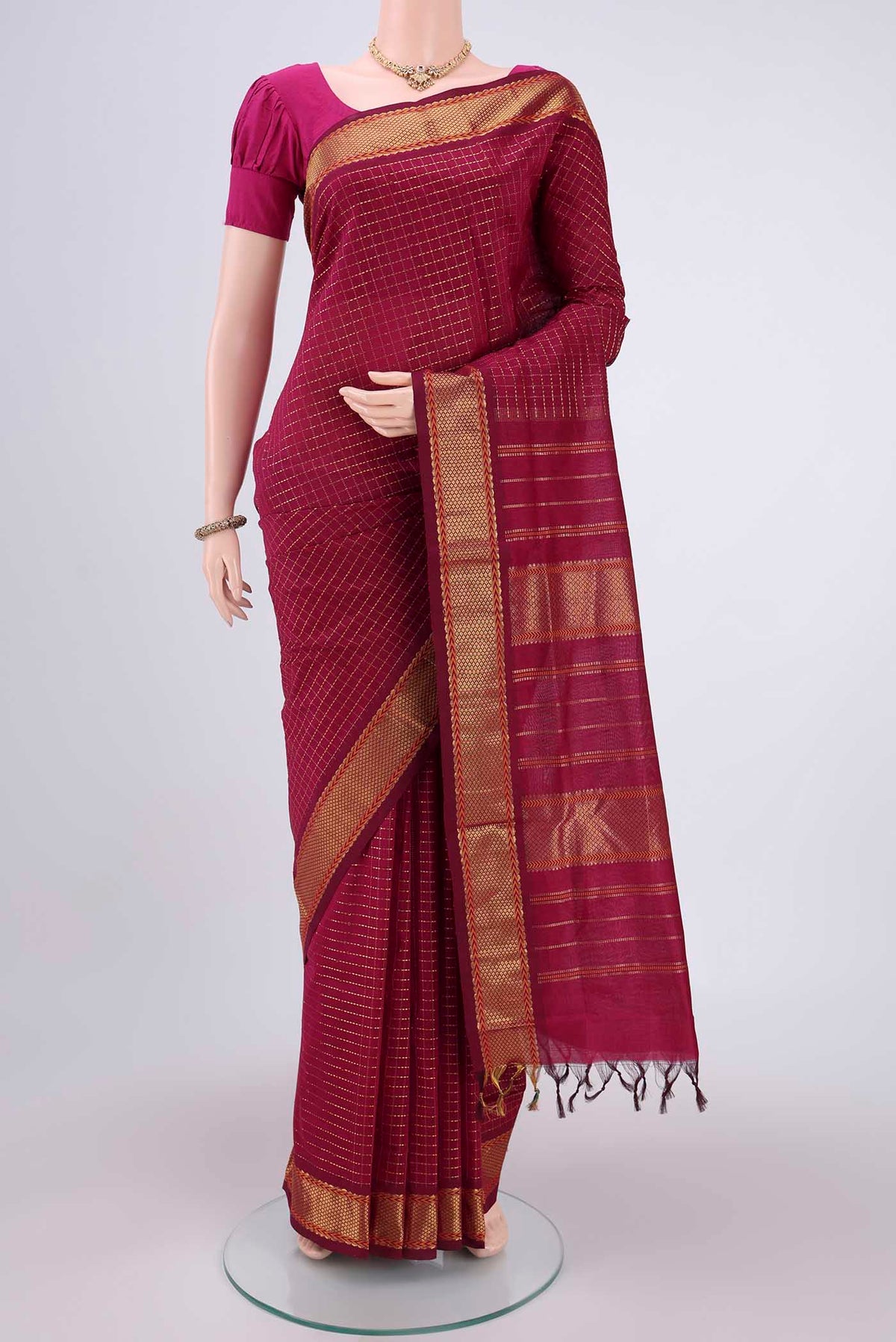 Magenta Blended Poly Cotton Saree with Checked design on the body and Zari Border.  displayed on a mannequin