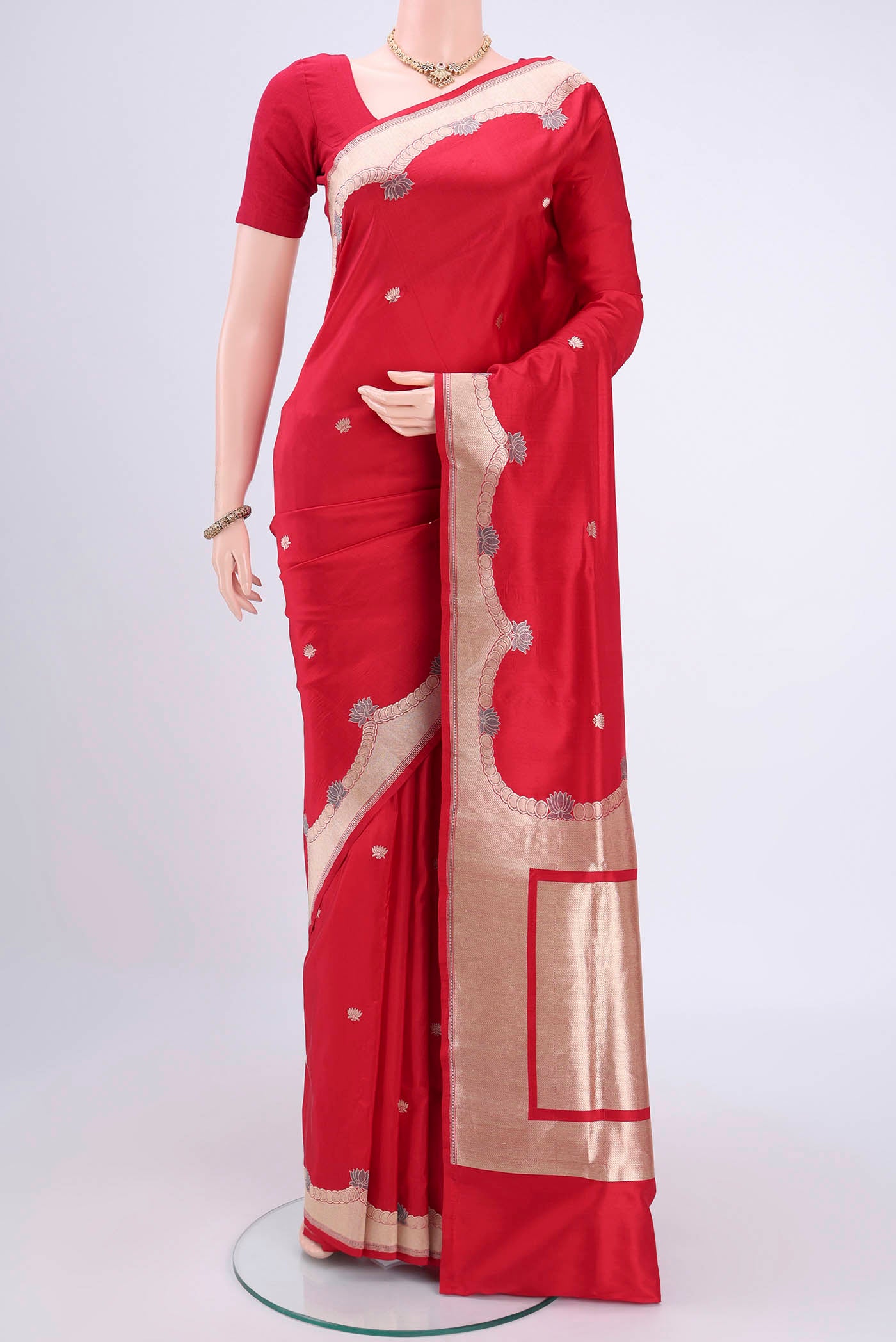 Red Banarasi Silk Saree with Zari Butta on the body and Zari Border.  displayed on a mannequin