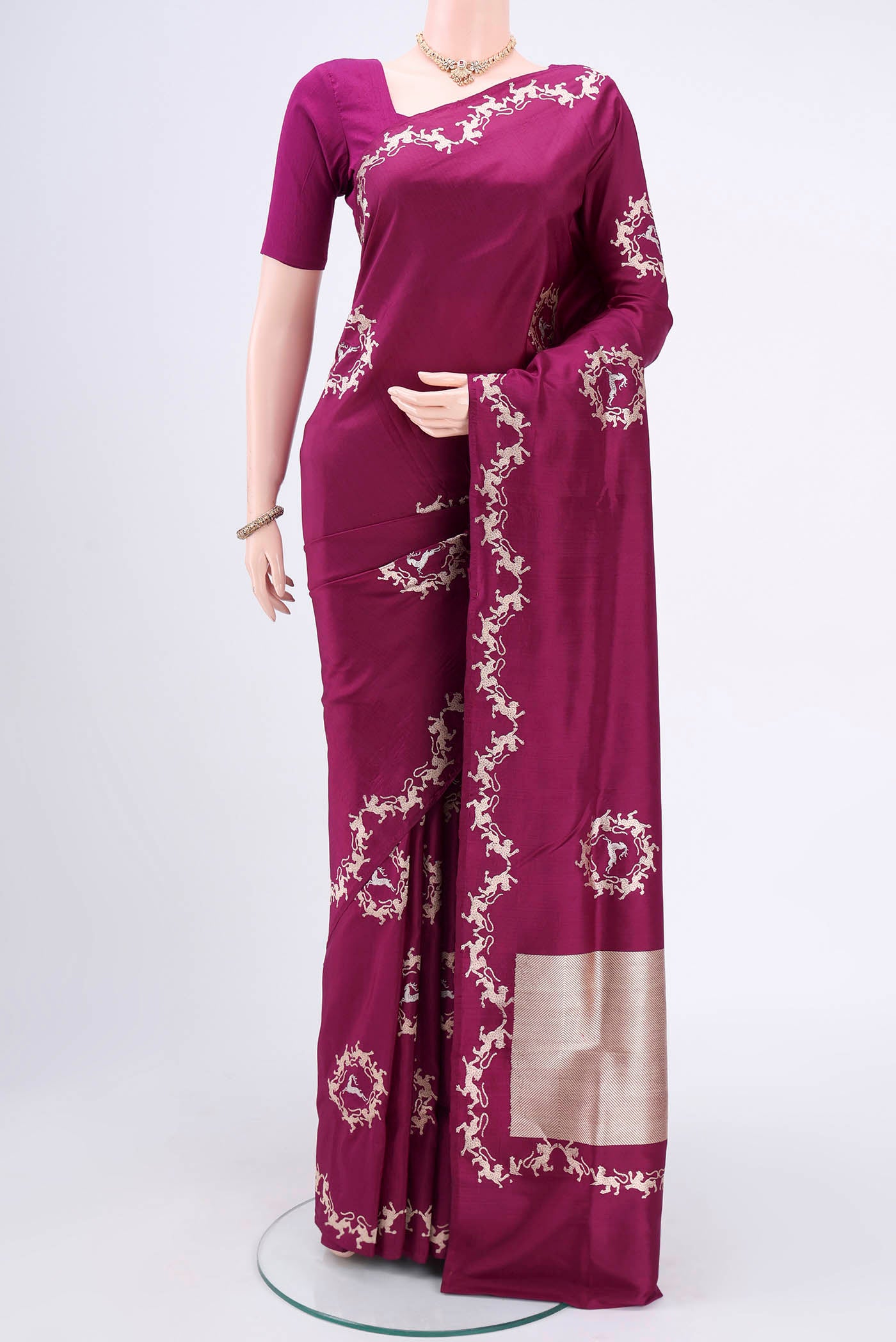 Magenta Banarasi Silk Saree with Zari Butta on the body and Zari Border.  displayed on a mannequin