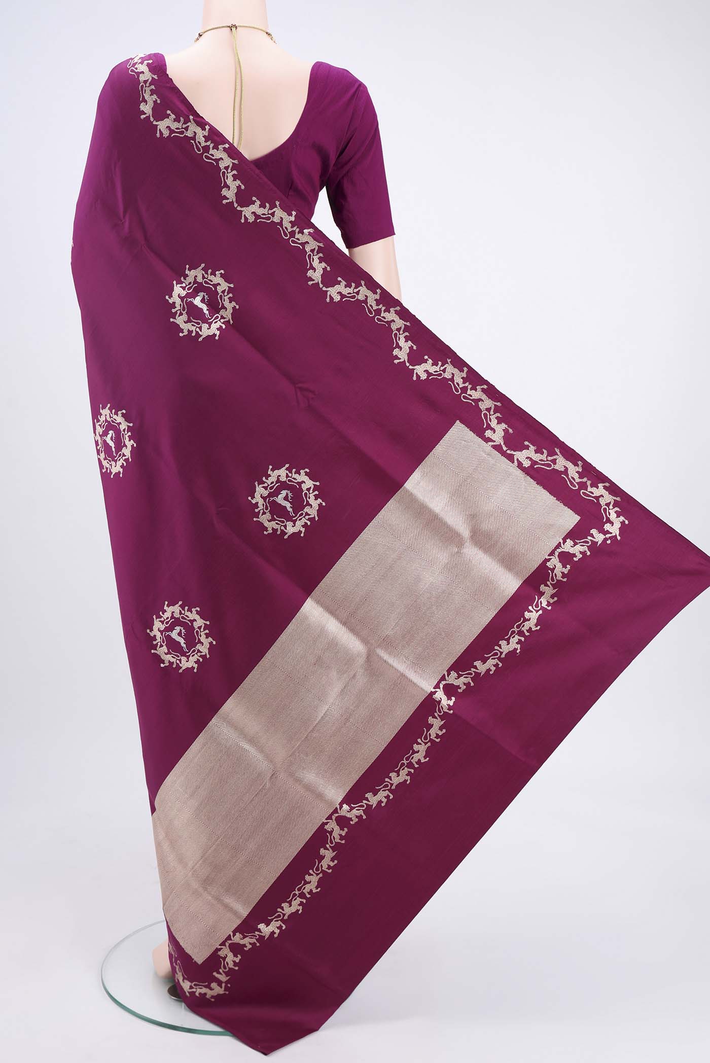 Flat view of Magenta Banarasi Silk Saree with Zari Butta on the body and Zari Border. 