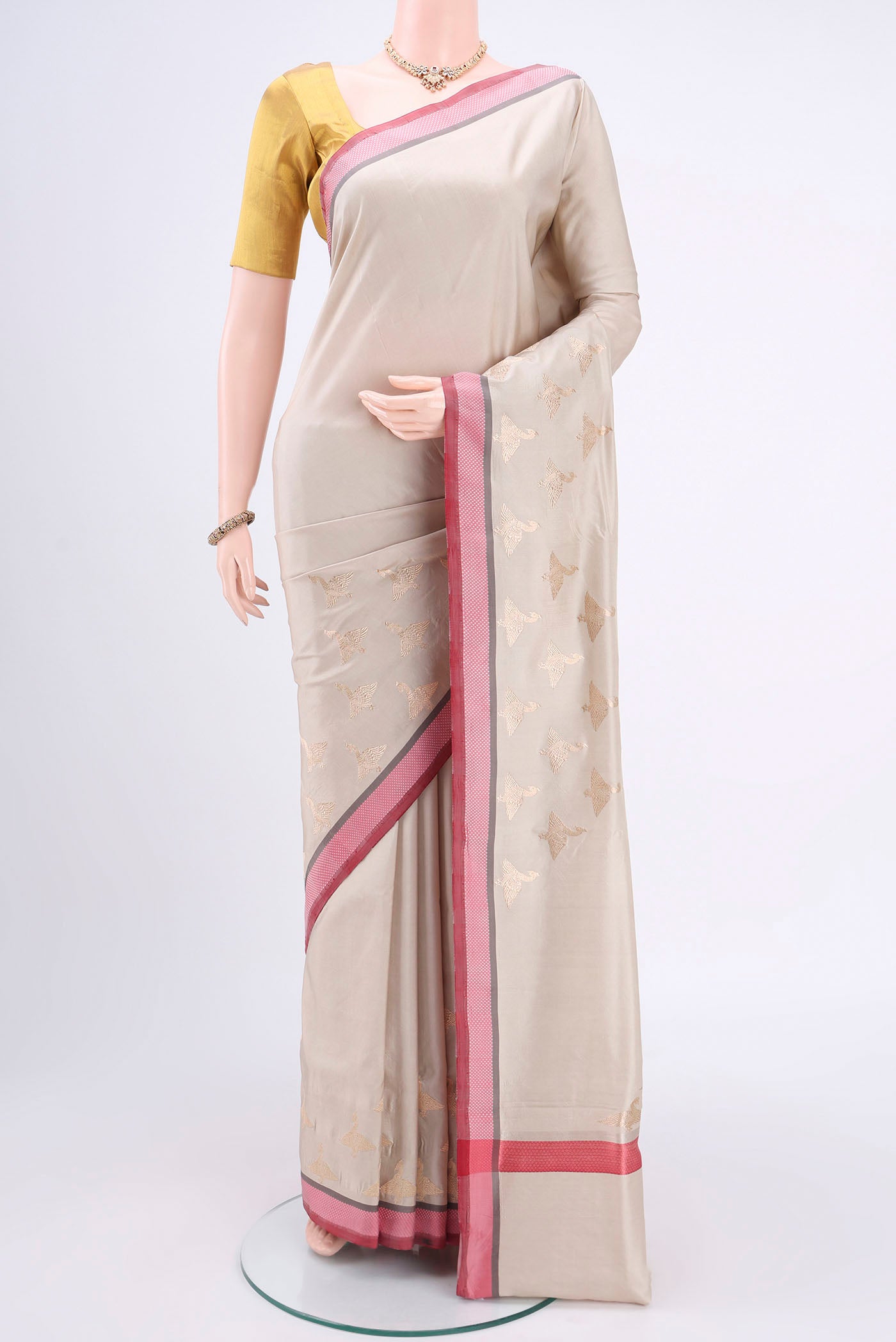 Beige Banarasi Silk Saree with Plain Body and Zari And Thread Border.  displayed on a mannequin
