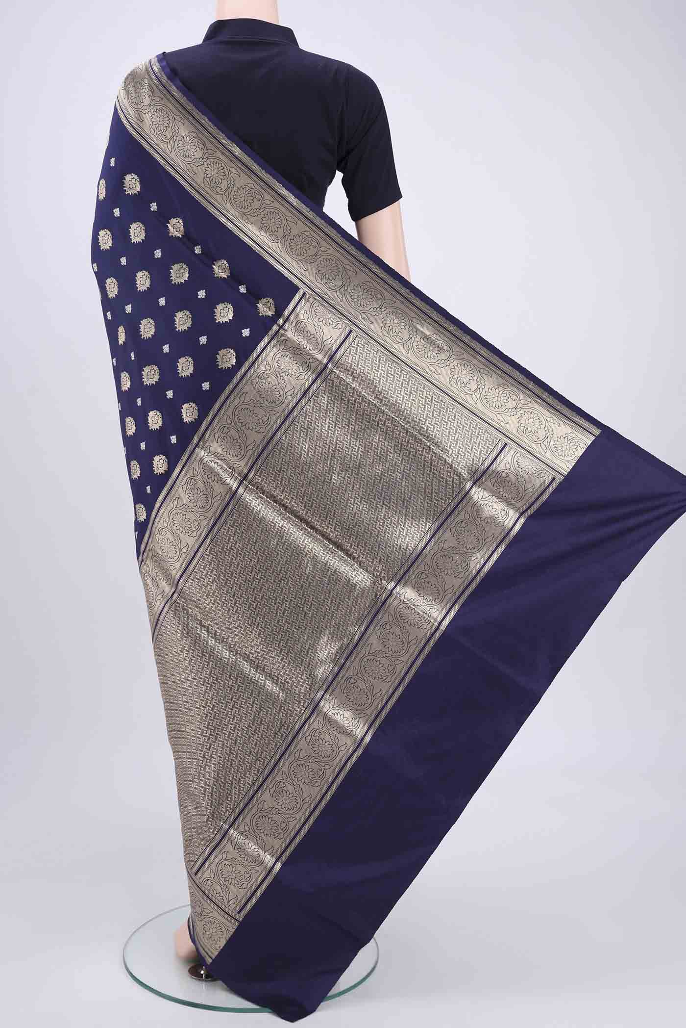 Flat view of Navy Blue Banarasi Silk Saree with Zari Butta on the body and Zari Border. 
