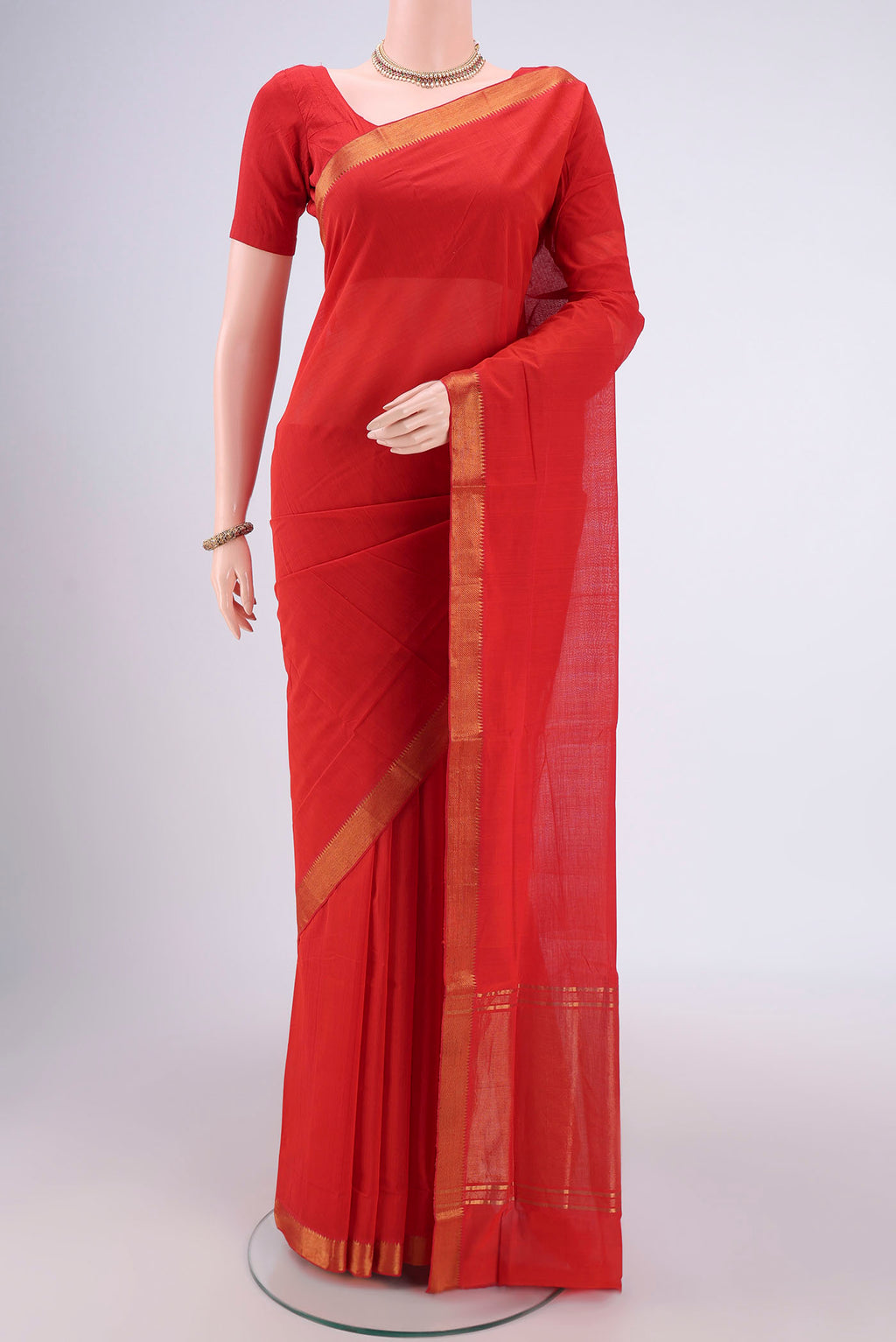 Saffron Mangalagiri Cotton Saree with Plain Body and Zari Border.  displayed on a mannequin