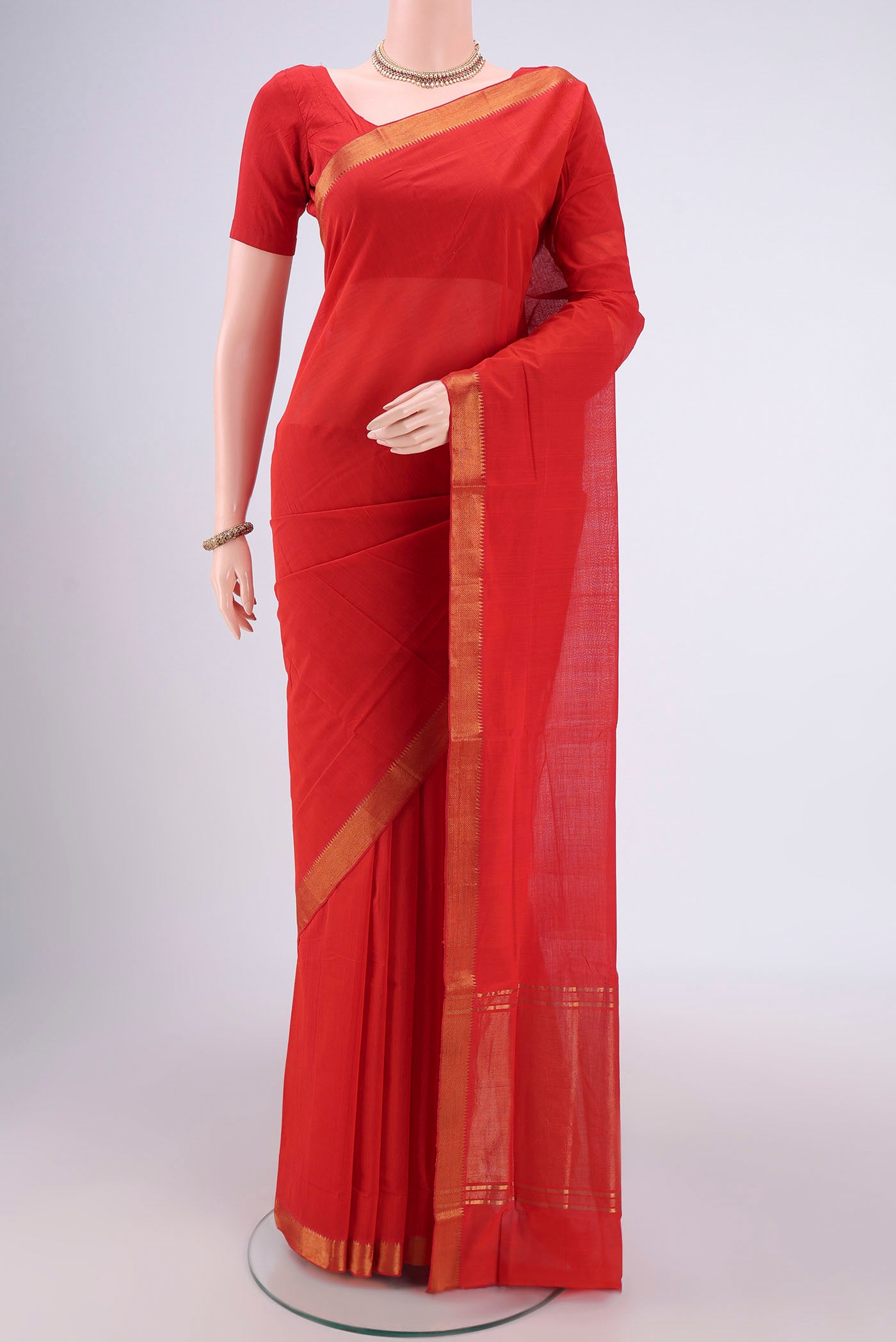 Saffron Mangalagiri Cotton Saree with Plain Body and Zari Border.  displayed on a mannequin