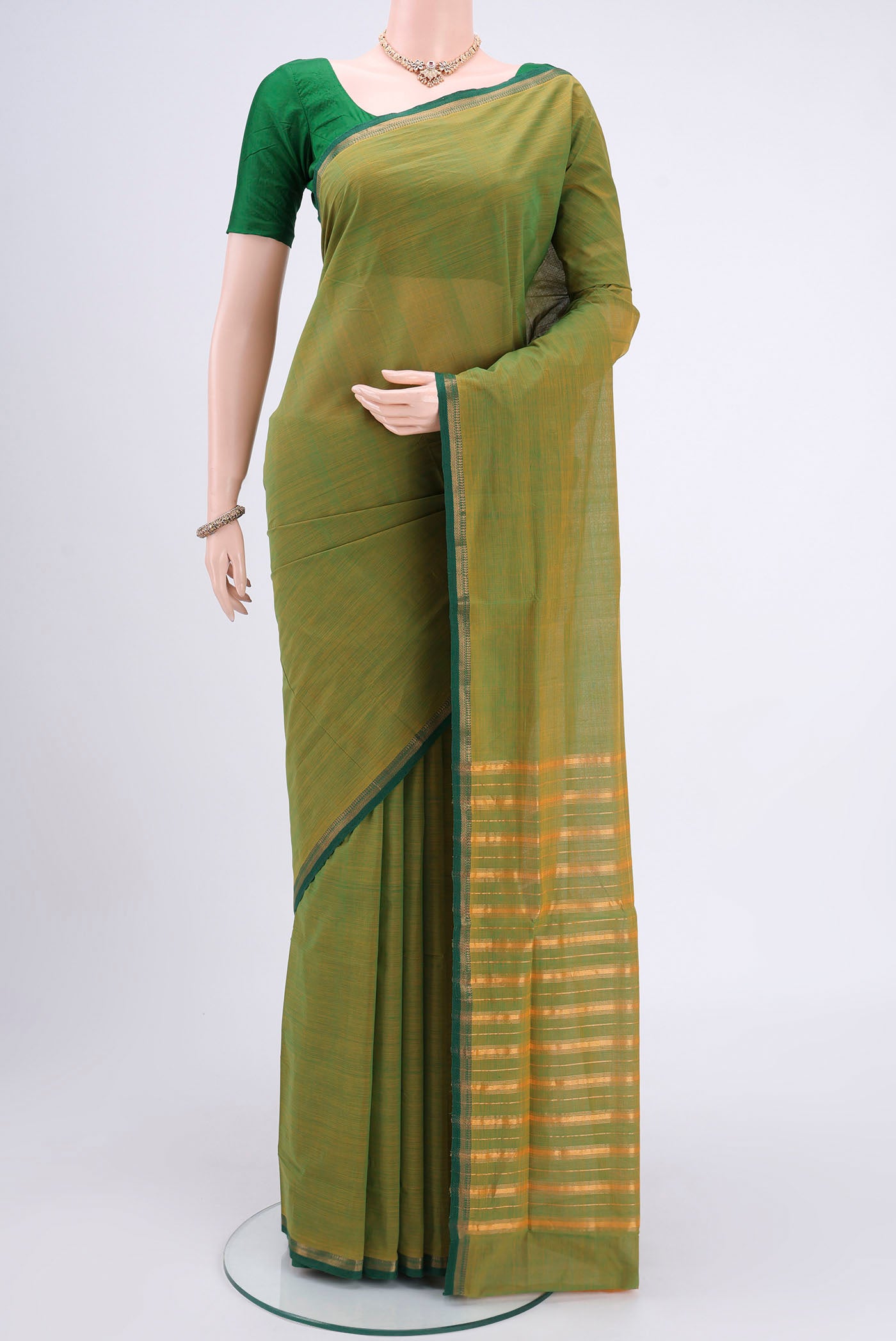 Light Green Mangalagiri Cotton Saree with Plain Body and Zari Border.  displayed on a mannequin