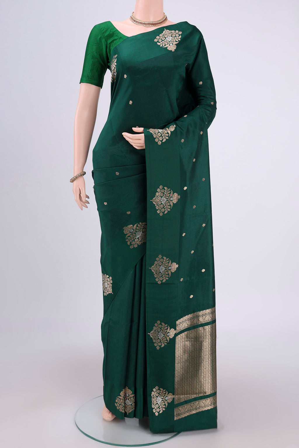 Green Banarasi Katan Silk Saree with Zari Butta on the body and Zari Border.  displayed on a mannequin